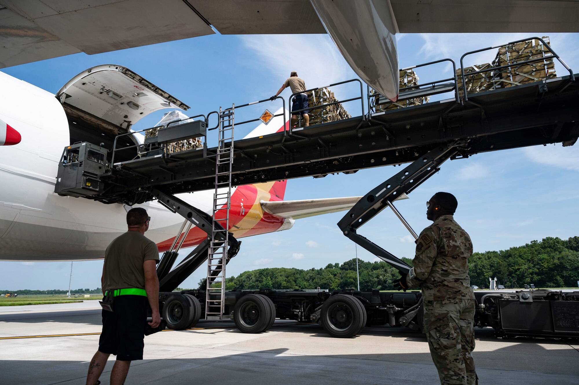 Airmen from the 436th Aerial Port Squadron assist in loading ammunition onto a commercial plane bound for Ukraine during a security assistance mission at Dover Air Force Base, Delaware, July 21, 2022. The Department of Defense is providing Ukraine with critical capabilities to defend against Russian aggression under the Ukraine Security Assistance initiative. (U.S. Air Force photo by Senior Airman Faith Schaefer)
