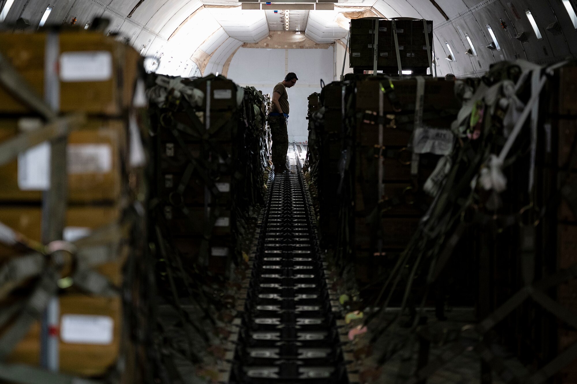 Senior Airman Nicholas Surdukowski, 436th Aerial Port Squadron ramp services specialist, assists in loading ammunition onto a commercial plane bound for Ukraine during a security assistance mission at Dover Air Force Base, Delaware, July 21, 2022. The Department of Defense is providing Ukraine with critical capabilities to defend against Russian aggression under the Ukraine Security Assistance initiative. (U.S. Air Force photo by Senior Airman Faith Schaefer)