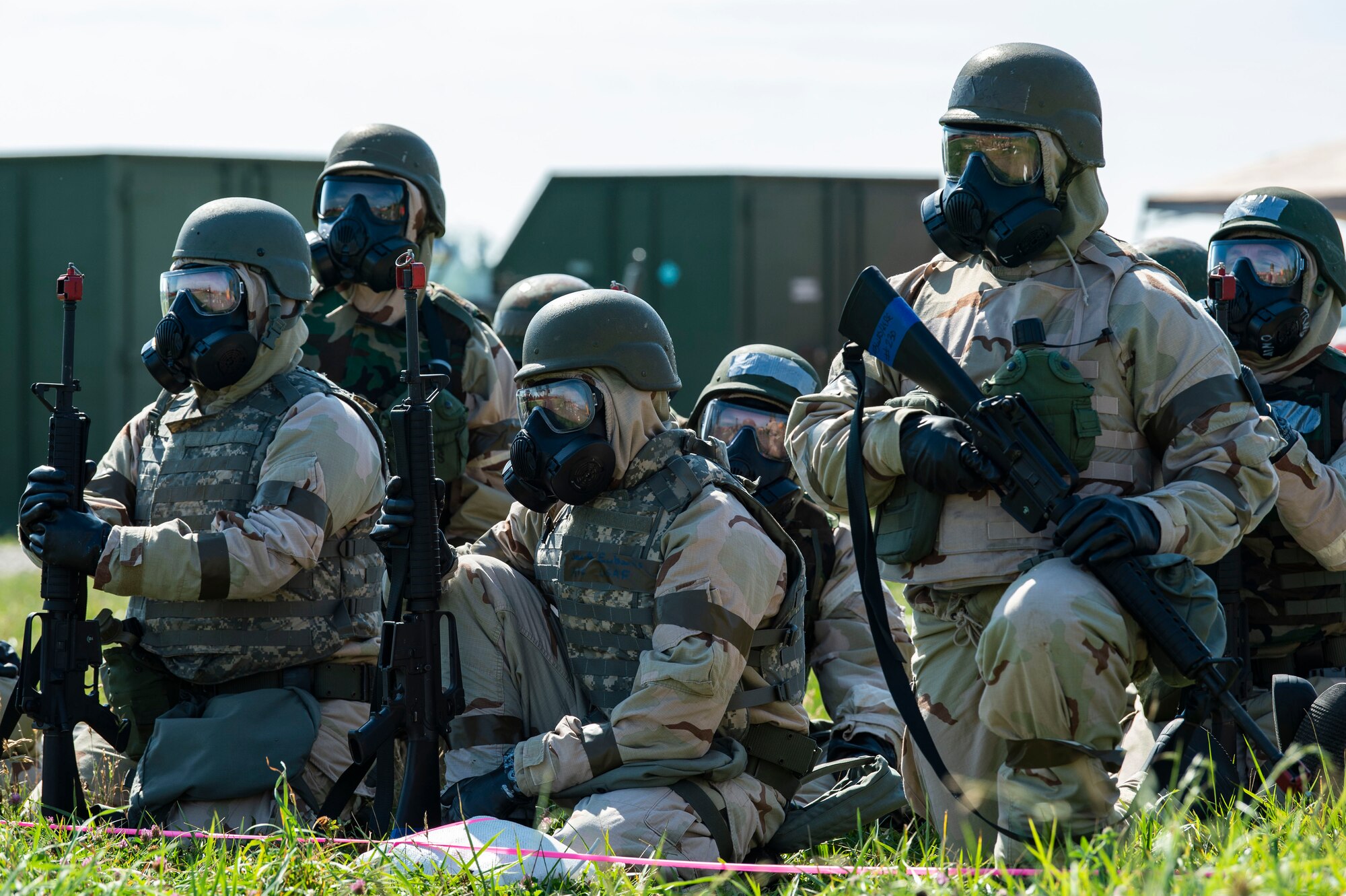 Team Dover members wearing training protective gear at a simulated forward operating base, sit in a simulated shelter during Liberty Eagle Readiness Exercise 2022 at Dover Air Force Base, Delaware, July 13, 2022. The 436th and 512th Airlift Wings tested their ability to generate, employ and sustain airpower across the world in a contested and degraded operational environment. (U.S. Air Force photo by Roland Balik)