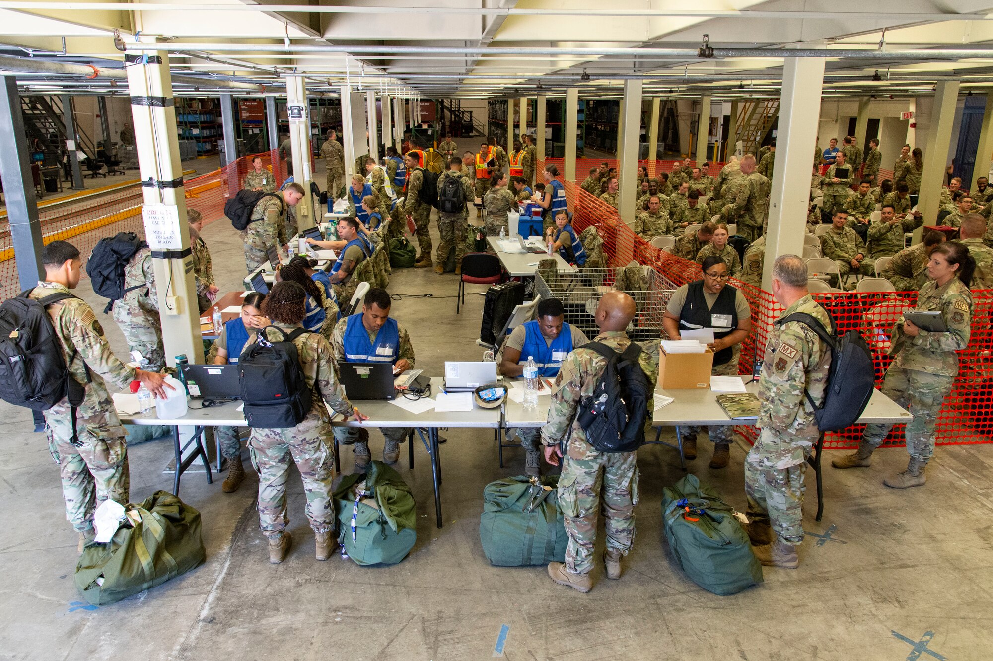Team Dover members process through the personnel deployment function line during Liberty Eagle Readiness Exercise 2022 at Dover Air Force Base, Delaware, July 11, 2022. The 436th and 512th Airlift Wings tested their ability to generate, employ and sustain airpower across the world in a simulated contested and degraded operational environment. (U.S. Air Force photo by Roland Balik)