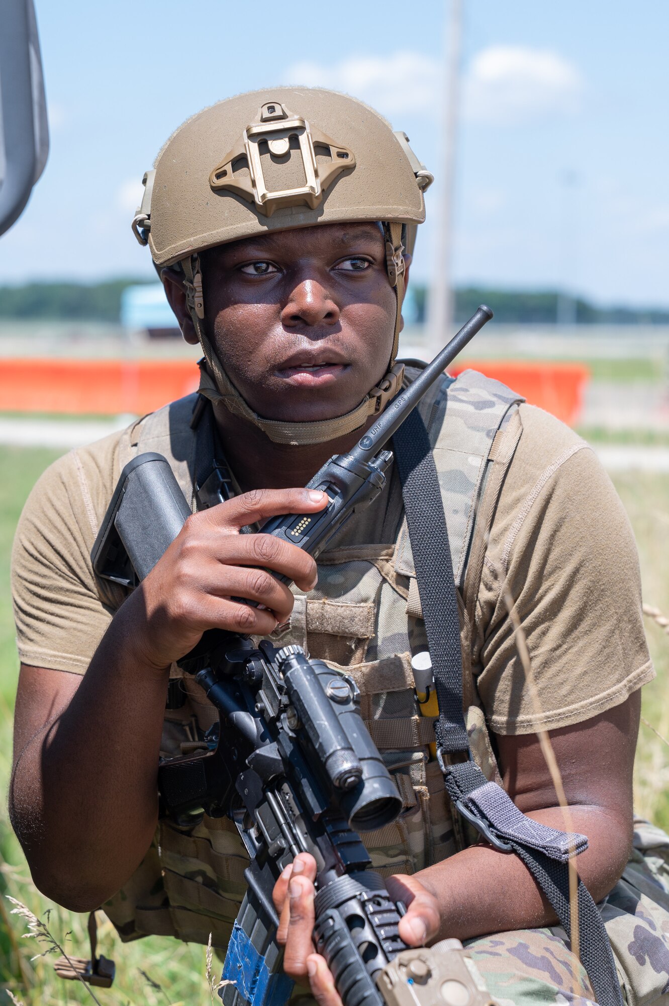 Senior Airman Qwesi Benson, 436th Security Forces Squadron response force member, awaits orders from his superior after responding to simulated armed attackers outside the camp perimeter during Liberty Eagle Readiness Exercise 2022 at Dover Air Force Base, Delaware, July 14, 2022. The 436th and 512th Airlift Wings tested their ability to generate, employ and sustain airpower across the world in a contested and degraded operational environment. (U.S. Air Force photo by Mauricio Campino)
