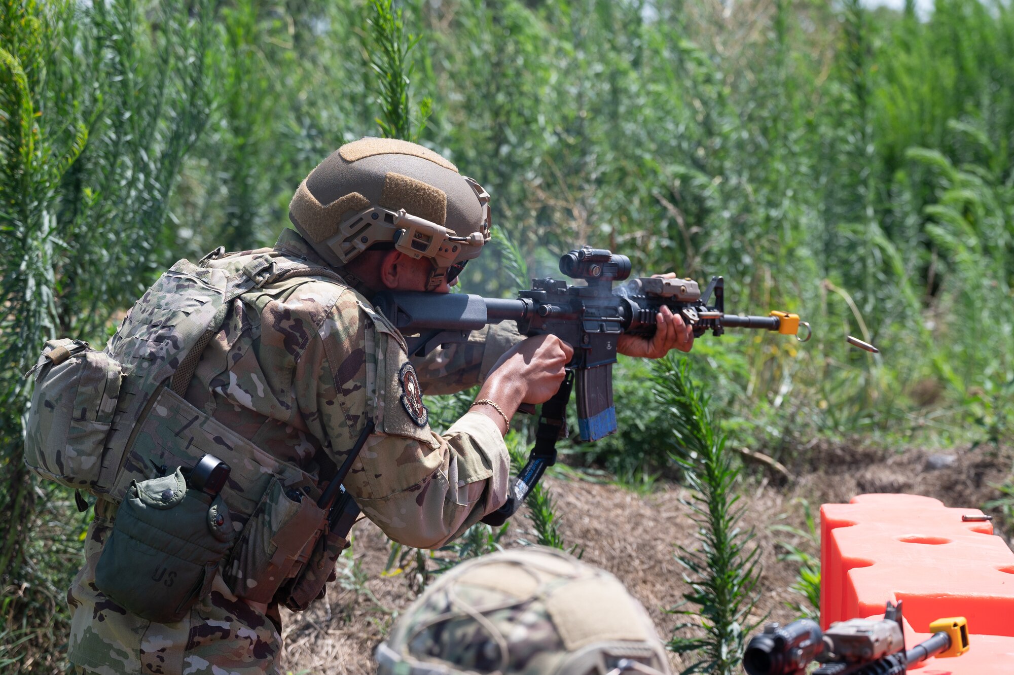 Senior Airman Shaun Jones, 436th Security Forces Squadron Raven, fires blank ammunition at simulated armed attackers outside the camp perimeter during Liberty Eagle Readiness Exercise 2022 at Dover Air Force Base, Delaware, July 14, 2022. The 436th and 512th Airlift Wings tested their ability to generate, employ and sustain airpower across the world in a contested and degraded operational environment. (U.S. Air Force photo by Mauricio Campino)