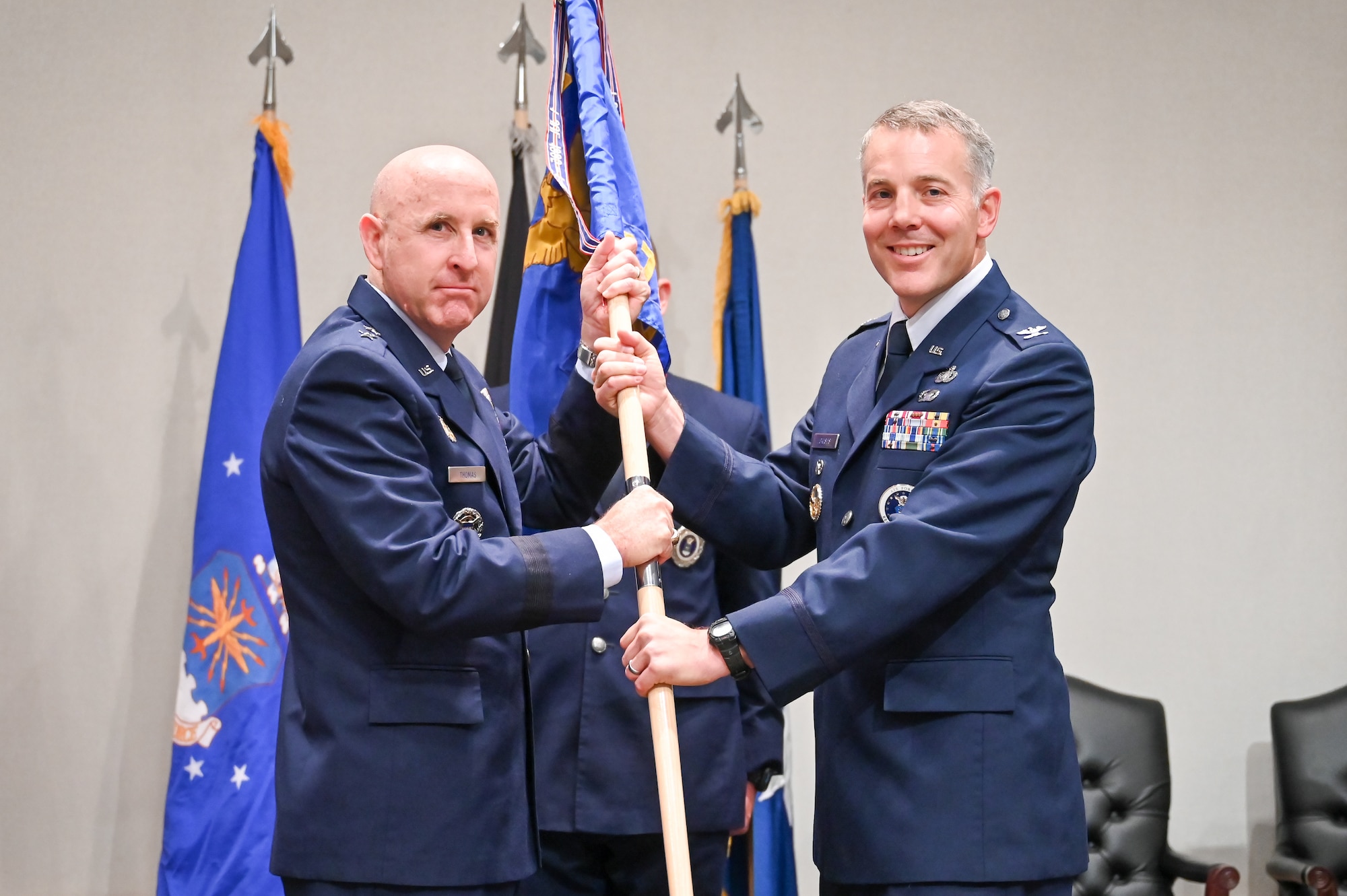 Right, Col. Joseph J. Egresits, incoming 372nd Recruiting Group commander, receives the guidon from Maj. Gen. Edward W. Thomas Jr., Air Force Recruiting Service commander, during a change of command ceremony