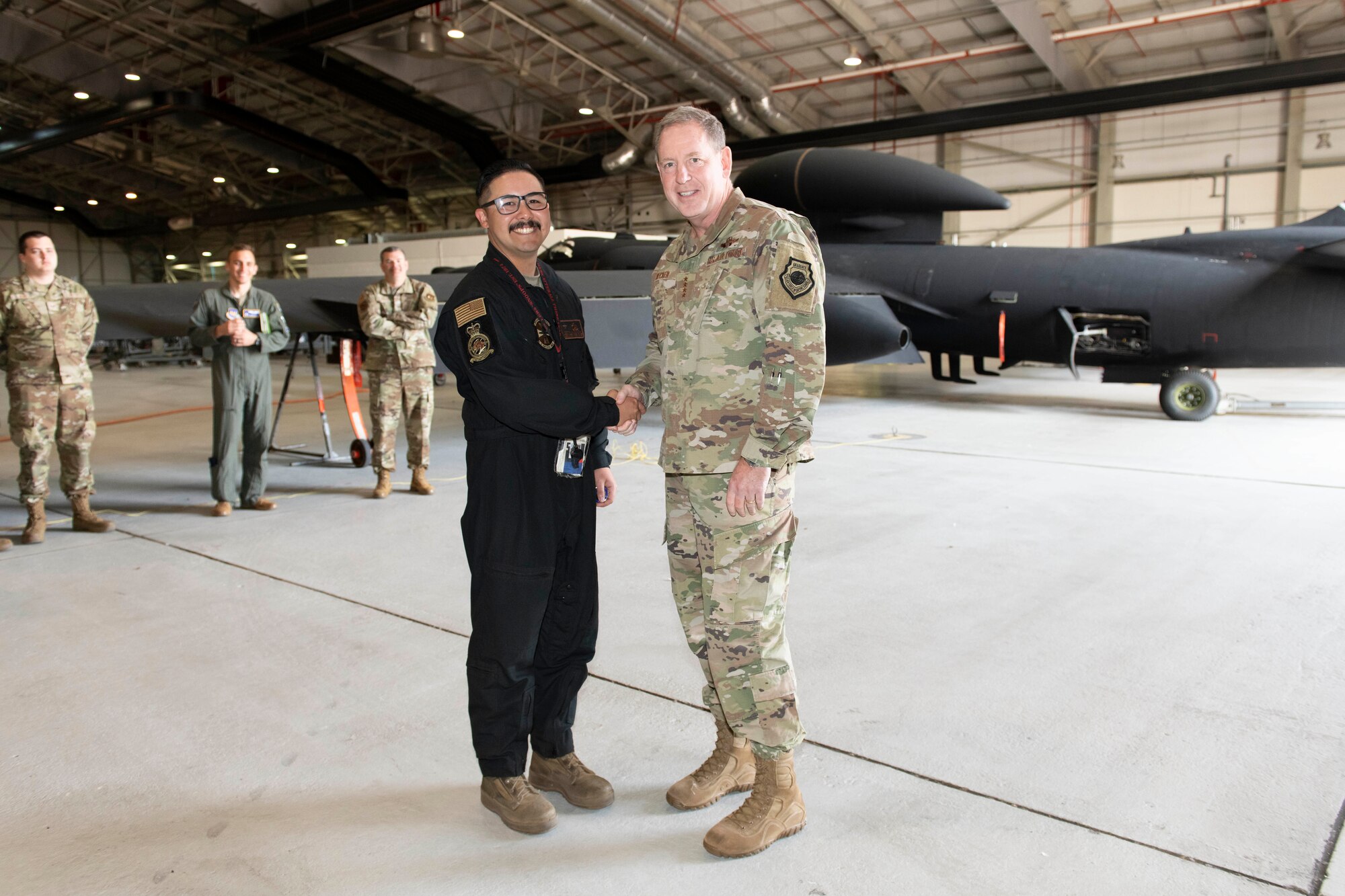 U.S. Air Force Gen. James B. Hecker, right, U.S. Air Forces in Europe and Air Forces Africa commander, recognizes Staff Sgt. Ryan Yamauchi, left, 99th Expeditionary Reconnaissance Squadron U-2 Dragon Lady dedicated crew chief, at Royal Air Force Fairford, England, July, 18, 2022. During his first visit to the 501st Combat Support Wing as the USAFE-AFAFRICA commander, Hecker met with several Airmen and received briefings about the wing’s mission and capabilities. (U.S. Air Force photo by Senior Airman Jennifer Zima)
