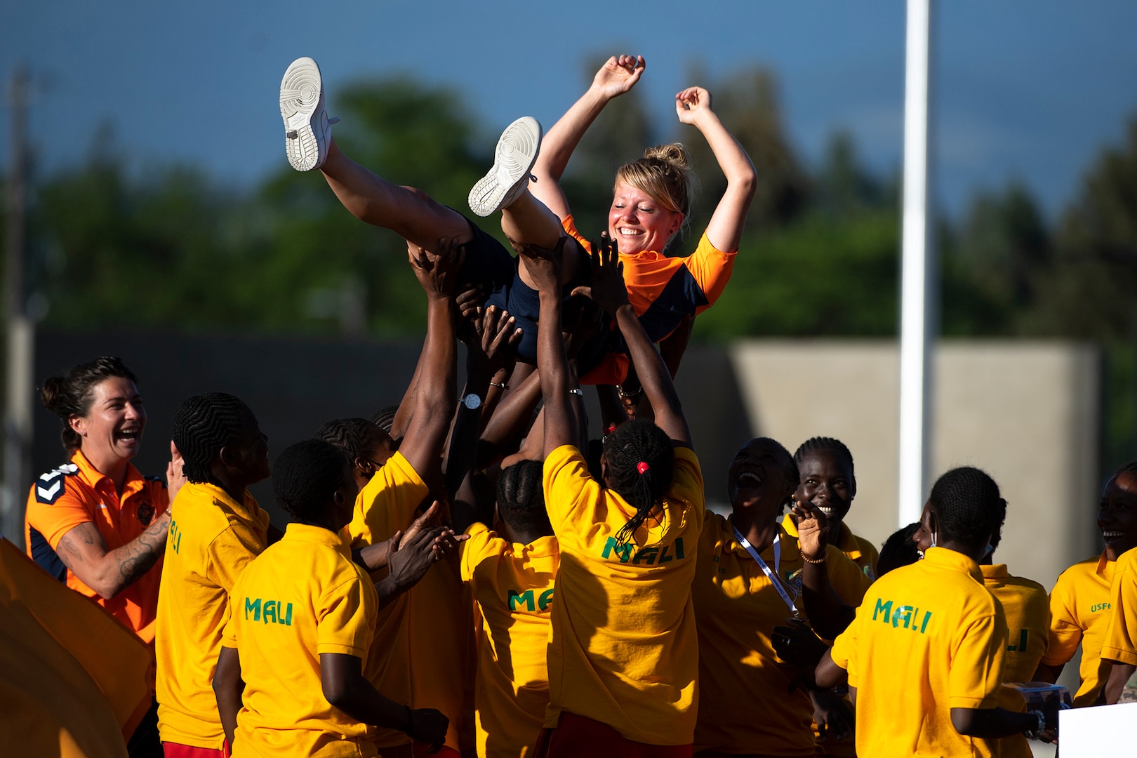 Team Mali lifts a Netherlands player during closing ceremonies for the 13th CISM (International Military Sports Council) World Military Women’s Football Championship in Meade, Washington July 22, 2022. (DoD photo by EJ Hersom)