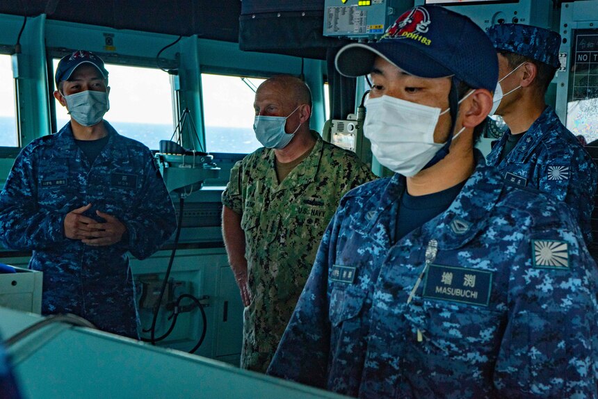 PACIFIC OCEAN (July 22, 2022) - Chief of Naval Operations Adm. Mike Gilday tours the Japan Maritime Self-Defense Force helicopter carrier JS Izumo (DDH-183) during Rim of the Pacific (RIMPAC) 2022, July 22. Twenty-six nations, 38 ships, four submarines, more than 170 aircraft and 25,000 personnel are participating in RIMPAC from June 29 to Aug. 4 in and around the Hawaiian Islands and Southern California. The world's largest international maritime exercise, RIMPAC provides a unique training opportunity while fostering and sustaining cooperative relationships among participants critical to ensuring the safety of sea lanes and security on the world's oceans. (U.S. Navy photo by Chief Mass Communication Specialist Amanda R. Gray/Released)
