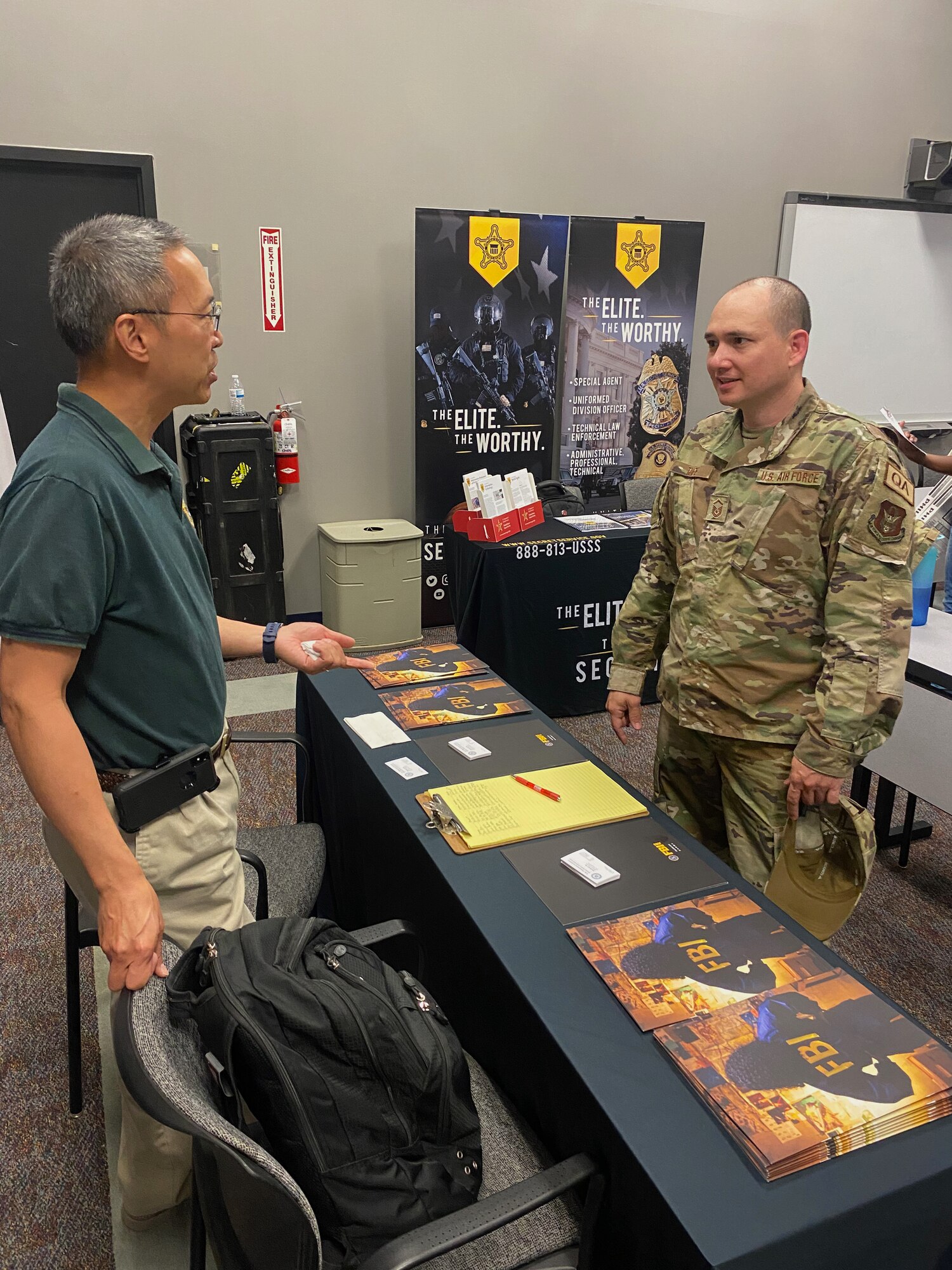 A member of the 514th Air Mobility Wing talks with a recruiter from the Federal Bureau of Investigations during a job fair held at the 514th Force Support Squadron on 22 July 2022.