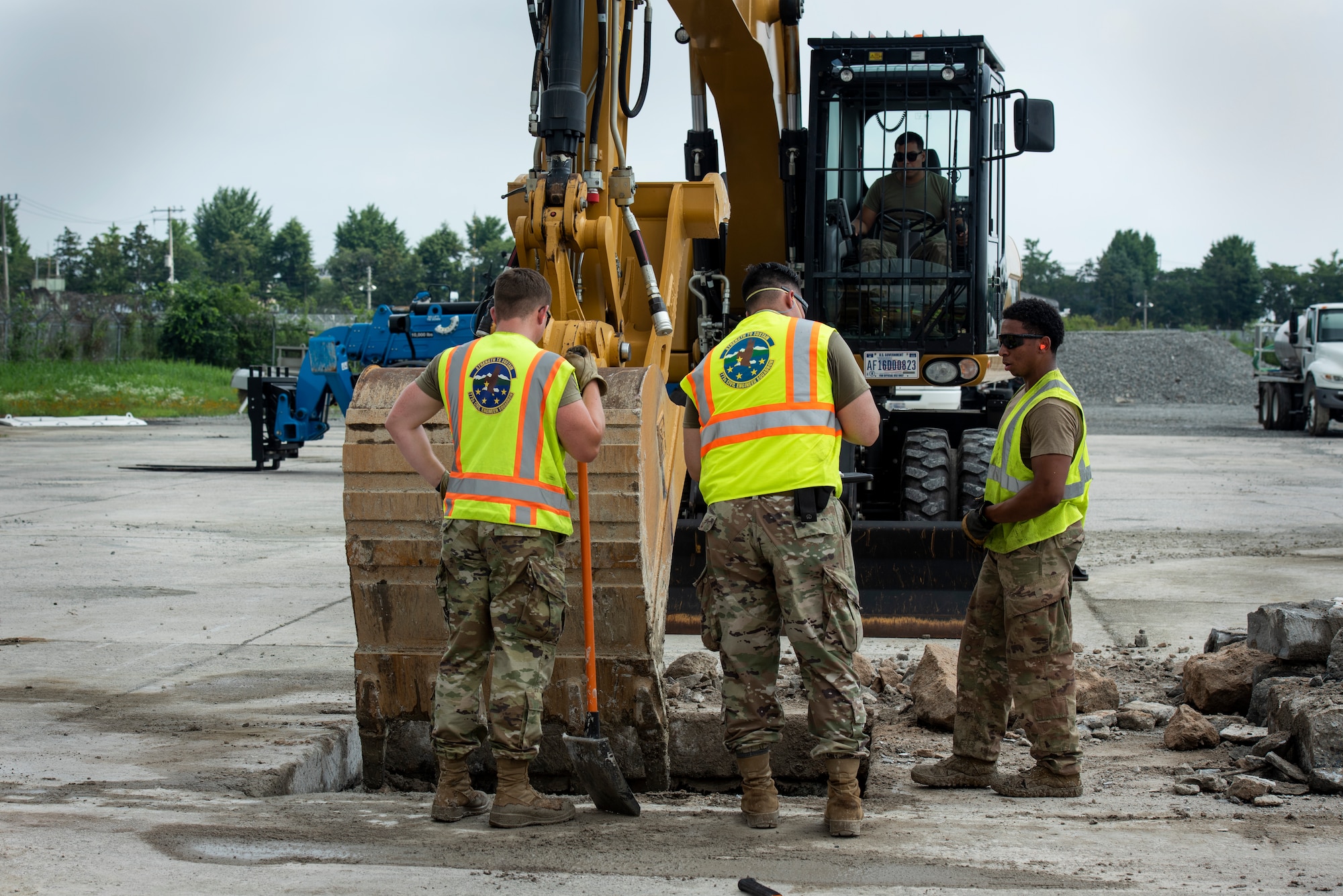 U.S. Air Force (USAF) Civil Engineer Airmen clear debris from a hole in a cement training pad during a rapid airfield damage repair training, July 19, 2022 at Gwangju Air Base, Republic of Korea