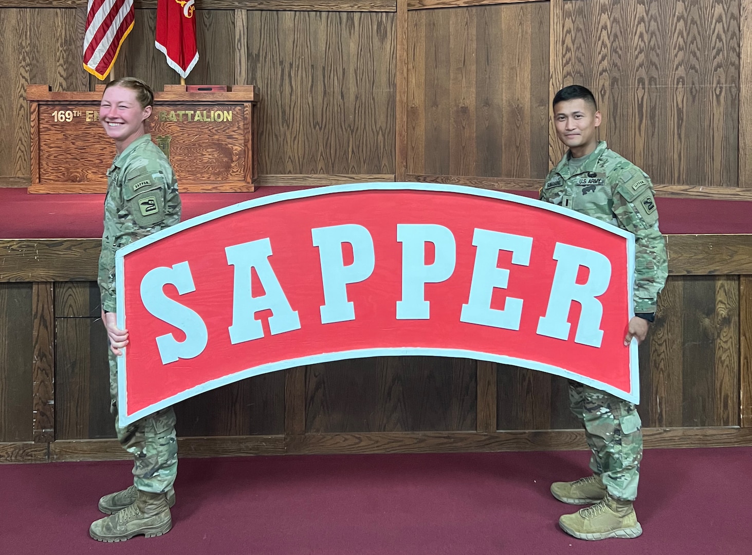 Spc. Lillyanne Clarke and 1st Lt. JP Sumayang, 898th Brigade Engineer Battalion, 81st Stryker Brigade Combat Team, Washington National Guard, hold the Sapper Tab after completing the Sapper Leader Course at Fort Leonard Wood, Missouri, July 1, 2022.