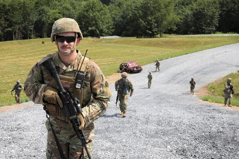 Sgt. Ryan Watts, a team leader and carpentry and masonry specialist assigned to the 160th Engineer Company, Delaware Army National Guard patrols with his squad through the Combined Arms Collective Training Facility at Fort Indiantown Gap, Pa. July 12, 2022 during the company’s annual training.