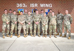 A group of Airmen pose for a group photo.