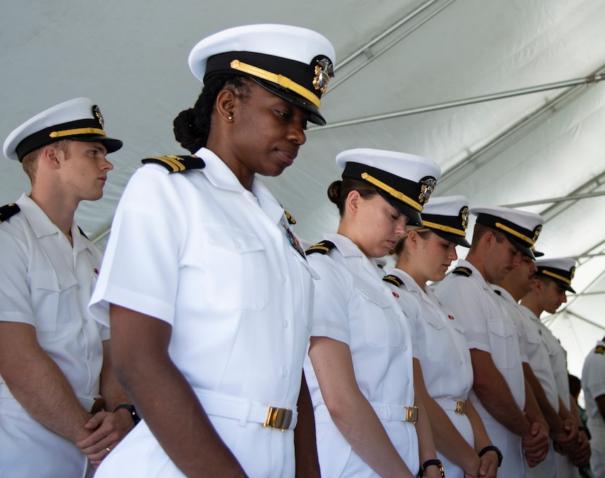 NEWPORT, R.I. (July 22, 2022) Navy Supply Corps School (NSCS) students lower their heads for the invocation during the NSCS change of command ceremony at Naval Station Newport, July 22. NSCS prepares newly commissioned Supply Corps officers from the U.S. Naval Academy, Officer Candidate School and Naval Reserve Officers Training Corps, as well as limited duty officers or officers who have been re-designated into the community, to serve in the fleet in entry-level positions. (U.S. Navy photo by Mass Communication Specialist 2nd Class Derien C. Luce)
