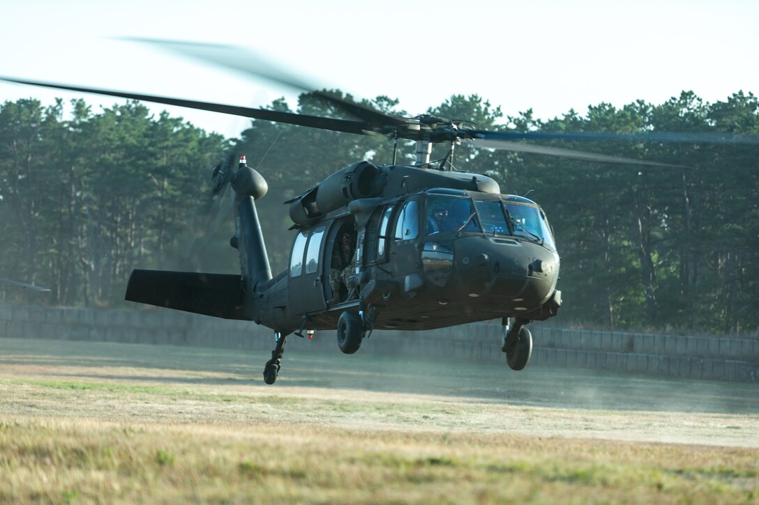 U.S. Army Soldiers with the 404th Civil Affairs Battallion touch down aboard a Black Hawk (UH-60) Helicopter during Operation Viking at Joint Base Cape Cod, Mass., July 20, 2022. Operation Viking is an intense joint task force exercise designed to prepare Soldiers with realistic training simulating deployment of civil affairs units in direct support of a contingency operation in Africa. (U.S. Army Photo by Staff Sgt. Keith Thornburgh)