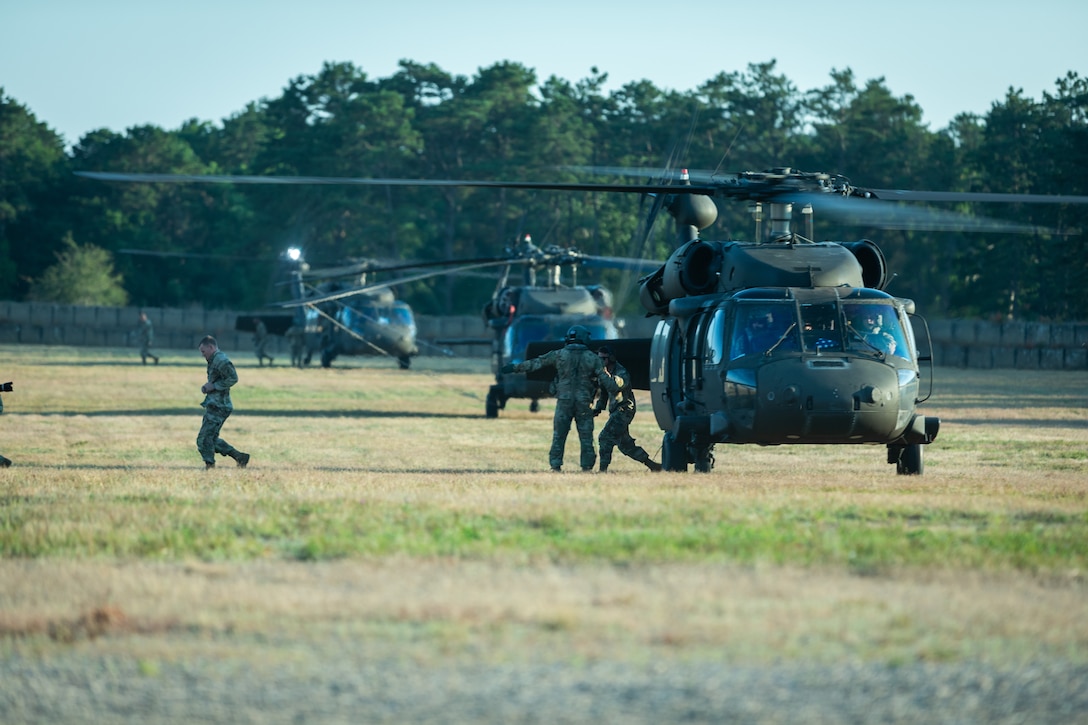 U.S. Army Soldiers with the 404th Civil Affairs Battallion exit a Black Hawk (UH-60) Helicopter during Operation Viking at Joint Base Cape Cod, Mass., July 20, 2022. Operation Viking is an intense joint task force exercise designed to prepare Soldiers with realistic training simulating deployment of civil affairs units in direct support of a contingency operation in Africa. (U.S. Army Photo by Staff Sgt. Keith Thornburgh)