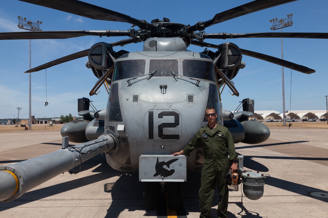 U.S. Marine Corps Staff Sgt. Joshua Perkins, a CH-53E Super Stallion crew chief with Marine Heavy Helicopter Squadron (HMH) 366, stands next to a CH-53E at Naval Air Station Joint Reserve Base (NAS JRB) Fort Worth, Texas, July 16, 2022. HMH-366 trained to ensure standardization and combat readiness in preparation for operational deployments. HMH-366 is a subordinate unit of 2nd Marine Aircraft Wing (MAW), the aviation combat element of II Marine Expeditionary Force. (U.S. Marine Corps photo by Pfc. Rowdy Vanskike)
