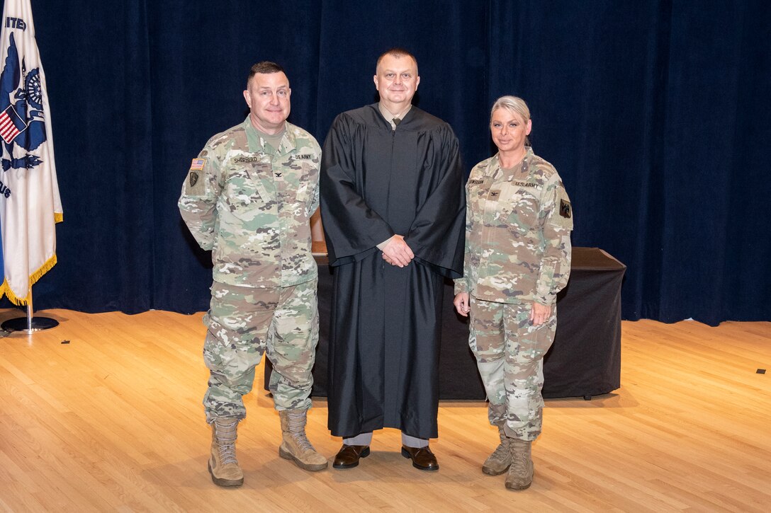 Army Col. Jason Shepherd (left), Army Lt. Col. Richard Couch, and Army Col. Natalie Lewellen participated in an robing ceremony after Couch completed the Military Judge Course at The Judge Advocate General's Legal Center and School in Charlottesville, Va. on July 1, 2022. (Photo courtesy of the Judge Advocate Generals Legal Center and School).