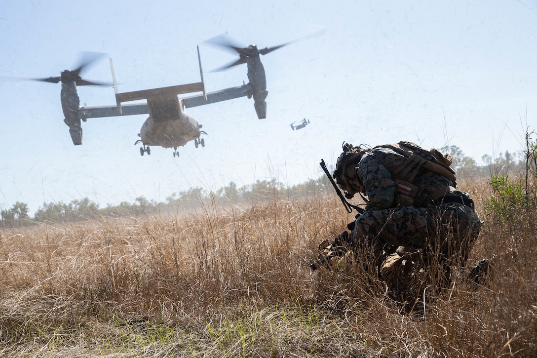 U.S. Marine Corps Staff Sgt. Anthony T. Graham, a platoon sergeant with 3rd Battalion, 7th Marine Regiment, Ground Combat Element, Marine Rotational Force-Darwin 22, braces while an MV-22 Osprey takes off during an air assault during exercise Koolendong 22 in Yampi Sound, WA, Australia, July 21, 2022. Exercise Koolendong 22 enhances MRF-D and the Australian Defence Force’s ability to conduct combined and joint operations, demonstrating the shared commitment to being ready to respond to a crisis or contingency in the Indo-Pacific region.