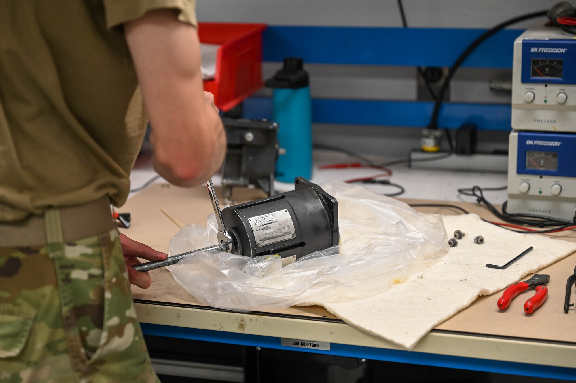 A photo of an Airman fixing a part.