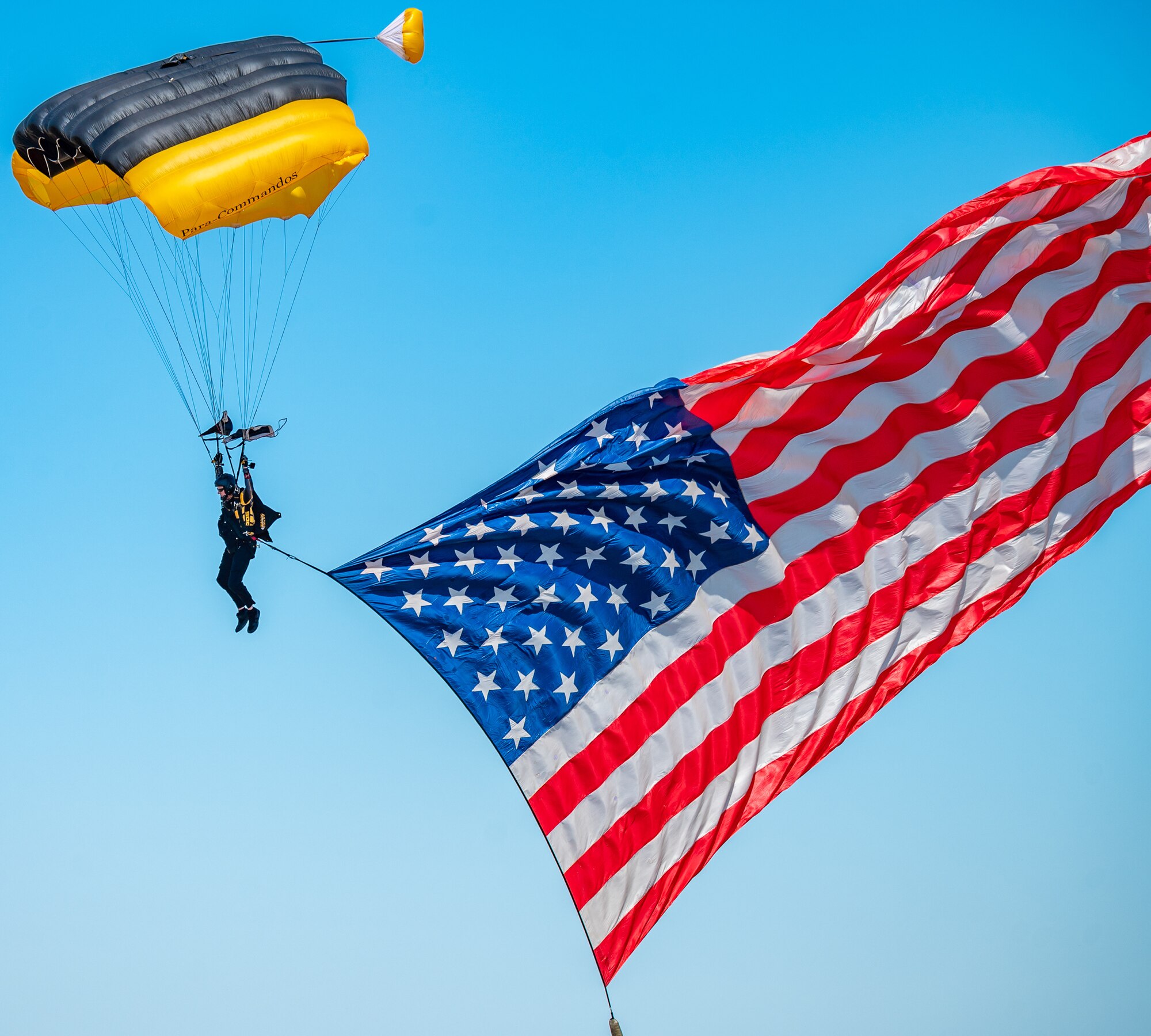 The U. S. Special Operations Command Parachute Team (Para-Commandos) parachute over the flightline during Montana's Military Open House "Flight Over the Falls" at Montana Air National Guard Base, Great Falls, Montana, July 23, 2022