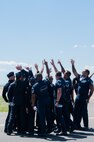 The U. S. Air Force Air Demonstration Squadron, known as the Thunderbirds, gather in a team huddle during Montana's Military Open House "Flight over the Falls" at Montana Air National Guard Base, Great Falls, Montana, July 23, 2022.