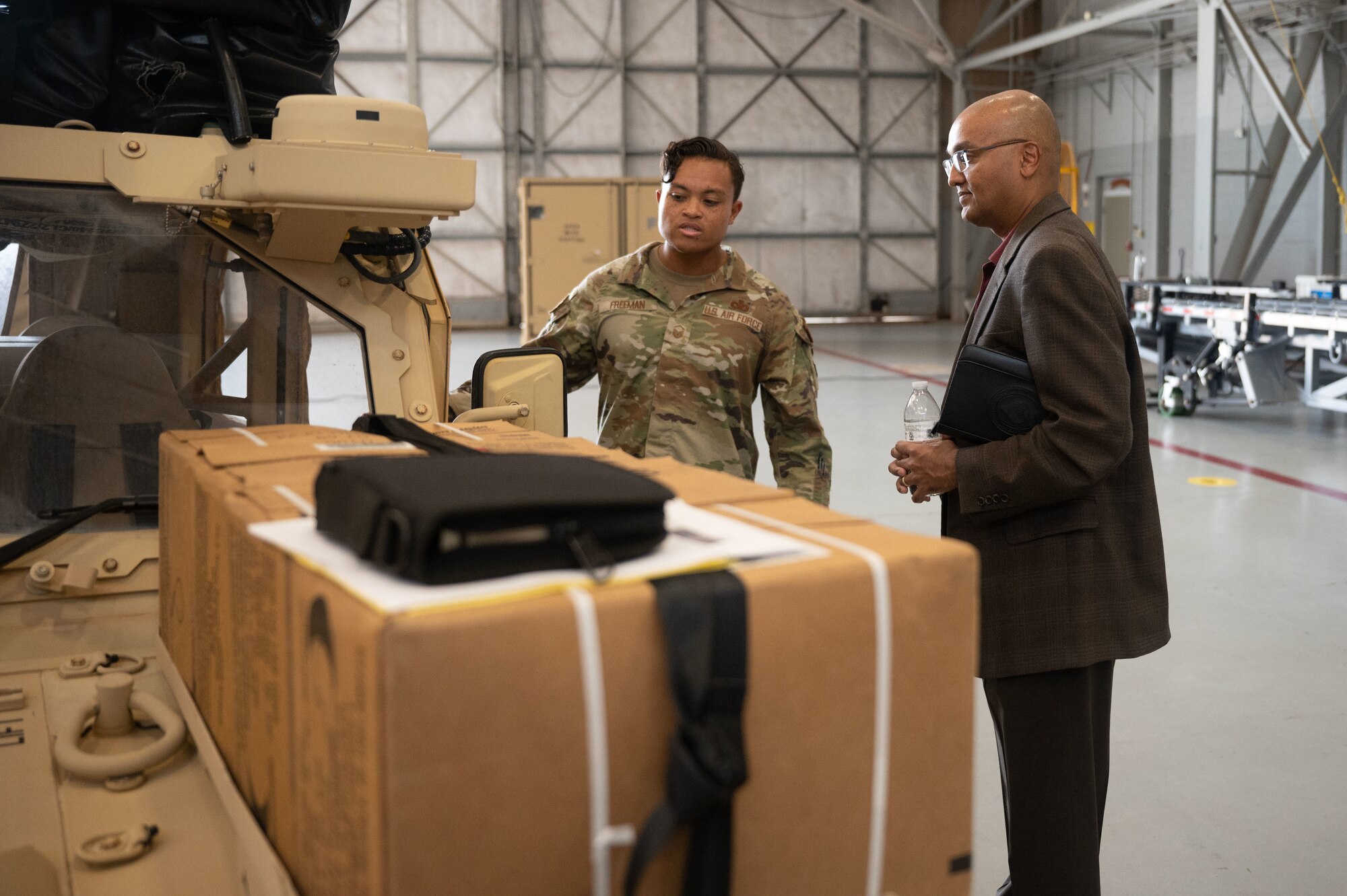 U.S. Air Force Master Sgt. Joseph Freeman, a Mission Sustainment Team member, speaks with Dr. Sandeep Mulgund, senior advisor to the Deputy Chief of Staff for Operations of the U.S. Air Force at Hurlburt Field, Florida, July 20, 2022. The MST works to establish forward operating bases in austere locations by providing initial site security, receiving cargo and personnel and setting up shelter