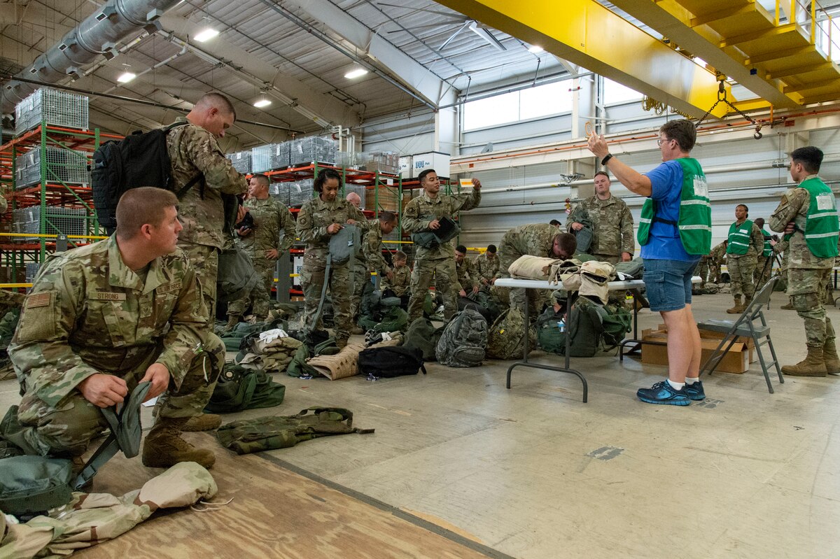 Team Dover members inventory their equipment as they process through the personnel deployment function line during Liberty Eagle Readiness Exercise 2022 at Dover Air Force Base, Delaware, July 11, 2022. The 436th and 512th Airlift Wings tested their ability to generate, employ and sustain airpower across the world in a simulated contested and degraded operational environment. (U.S. Air Force photo by Roland Balik)