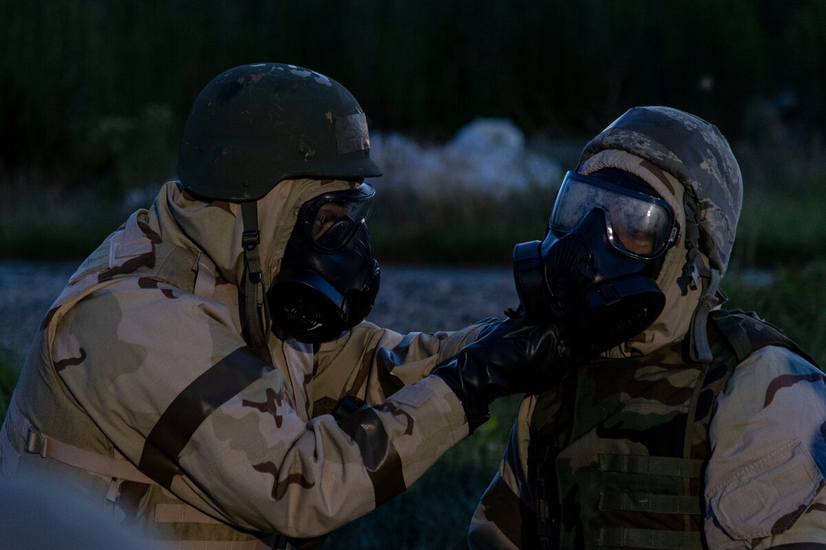 Team Dover members help each other don training protective gear prior to a simulated attack at a forward operating base during Liberty Eagle Readiness Exercise 2022 at Dover Air Force Base, Delaware, July 13, 2022. The 436th and 512th Airlift Wings tested their ability to generate, employ and sustain airpower across the world in a contested and degraded operational environment. (U.S. Air Force photo by Roland Balik)Team Dover members help each other don training protective gear prior to a simulated attack at a forward operating base during Liberty Eagle Readiness Exercise 2022 at Dover Air Force Base, Delaware, July 13, 2022. The 436th and 512th Airlift Wings tested their ability to generate, employ and sustain airpower across the world in a contested and degraded operational environment. (U.S. Air Force photo by Roland Balik)