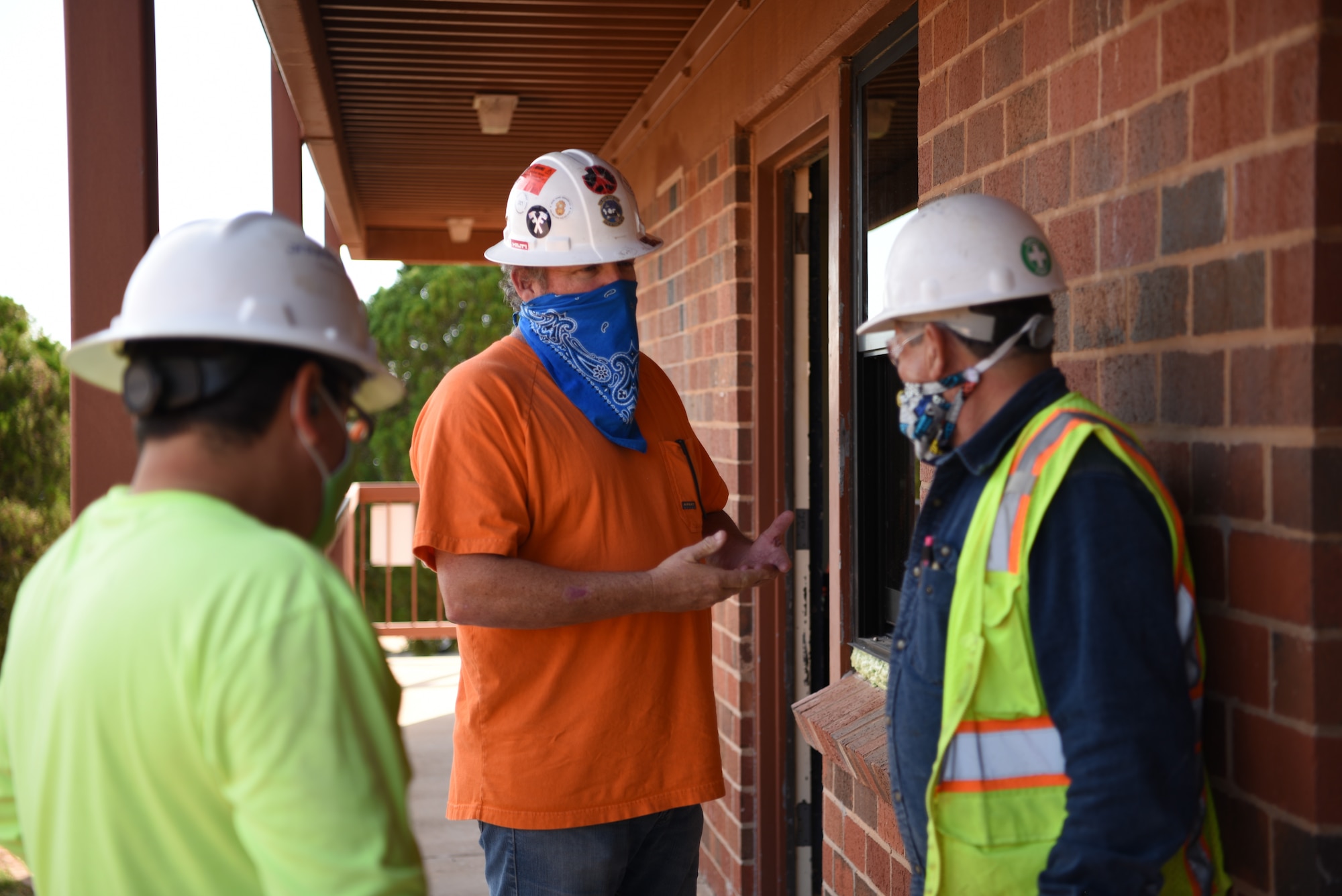 RJ Tingley (center), 7th Civil Engineer Squadron project manager, discusses next steps in a construction project at Dyess Air Force Base, Texas, Nov. 9, 2020. The 7th CES fulfills a wide array of work order requests and projects every year. (U.S. Air Force photo by Airman 1st Class Sophia Robello)