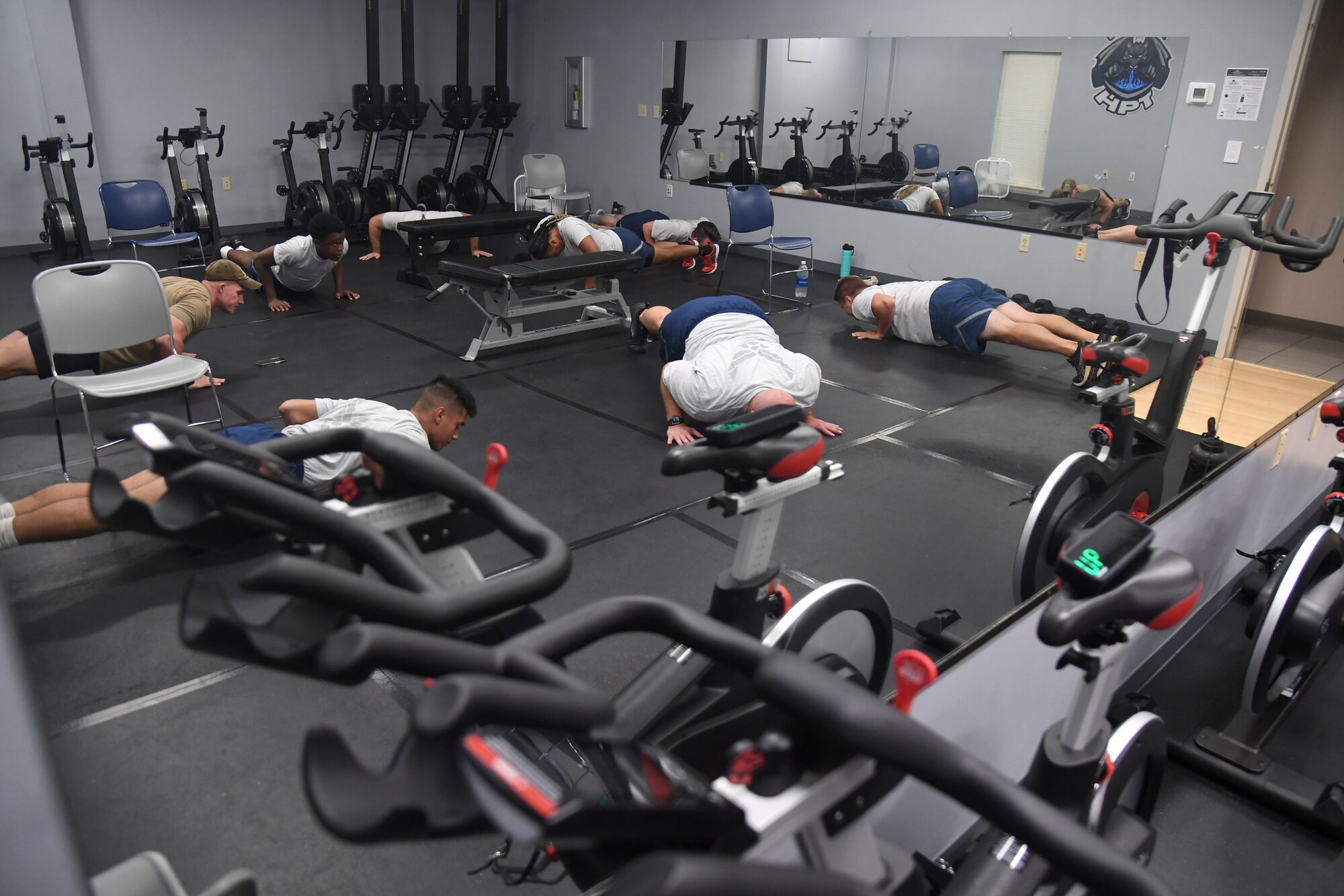Airmen participate in strength and conditioning exercises inside the Human Performance Training Center at Keesler Air Force Base, Mississippi, July 25, 2022. The purpose of the center is to develop healthy and resilient Airmen that are always operational and maintain a high level of readiness by providing participants with the tools, resources and knowledge needed to create healthy and sustainable habits. (U.S. Air Force photo by Kemberly Groue)