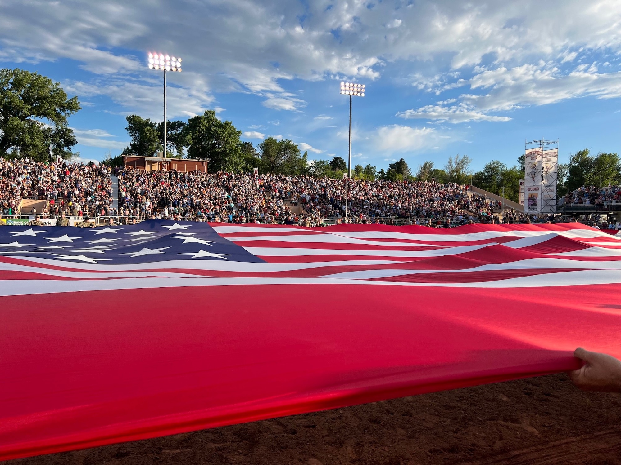 The Major, a giant American flag is unfurled by patriots from Hill AFB and other Utah service members celebrating Patriot Night at the Ogden Pioneer Days Rodeo opening ceremony July 22, 2022, in Ogden, Utah.