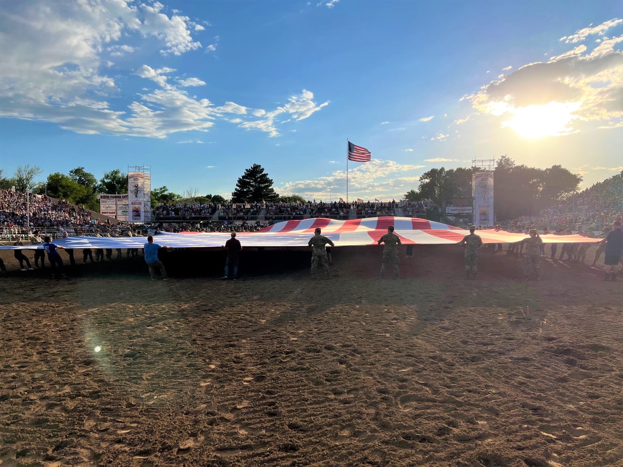 Patriots from Hill AFB joined other Utah service members and celebrated Patriot Night at the Ogden Pioneer Days Rodeo opening ceremony July 22, 2022, by unfurling and displaying “The Major,” a giant American flag in Ogden, Utah