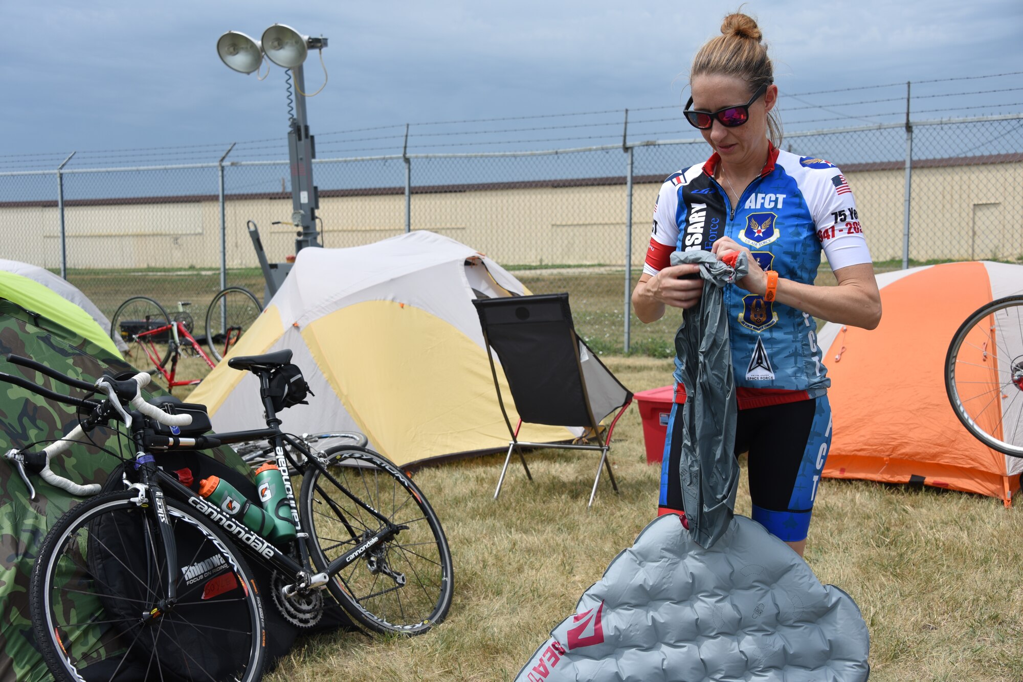 An AFCT member sets up her camping equipment