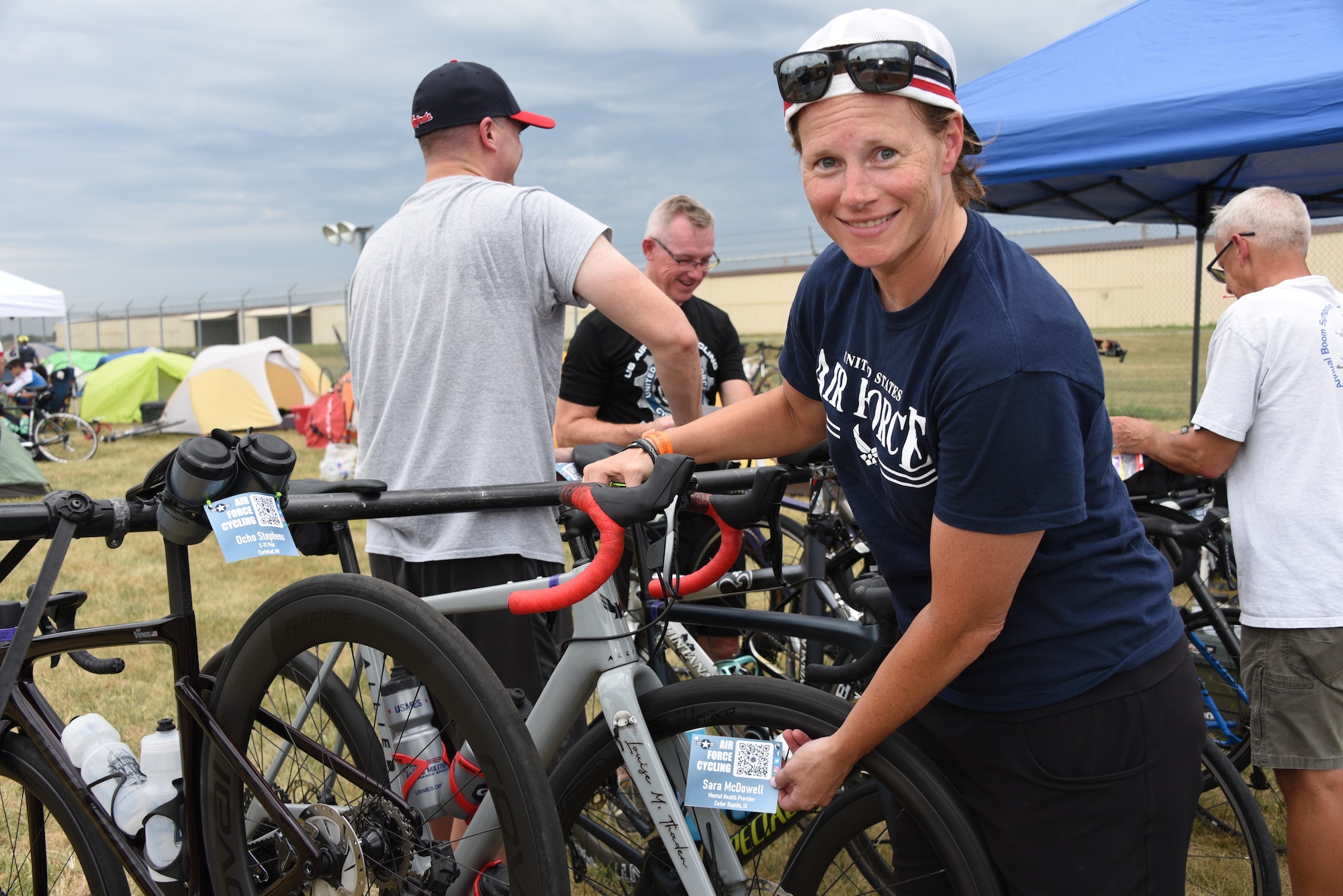 An AFCT member poses for a photo with her bicycle