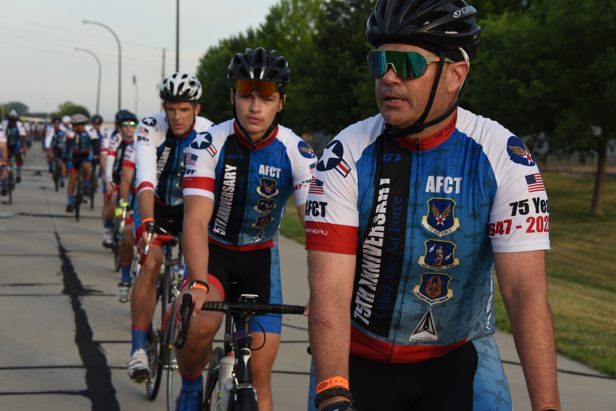 AFCT members ride down a road