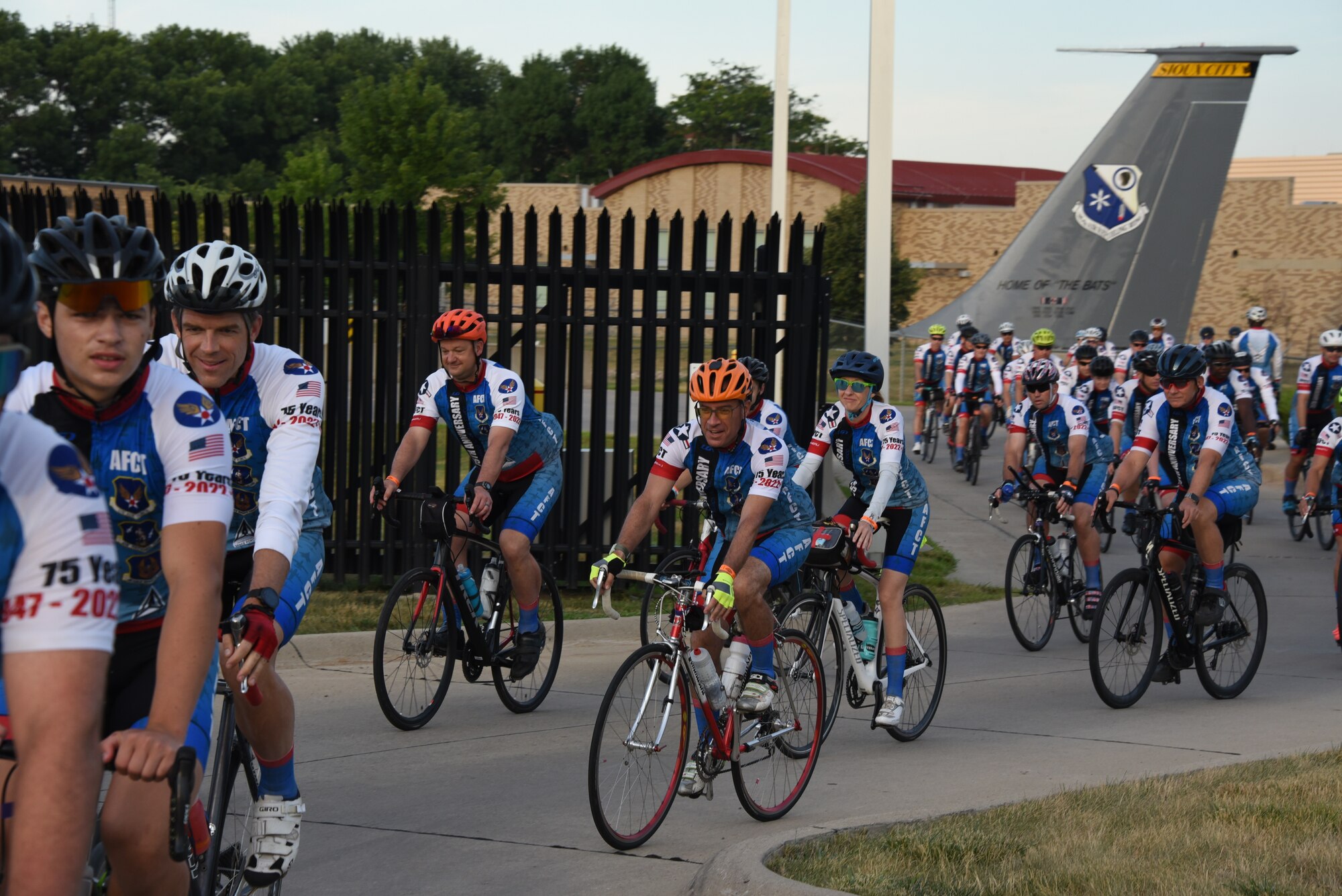 AFCT members ride through a gate