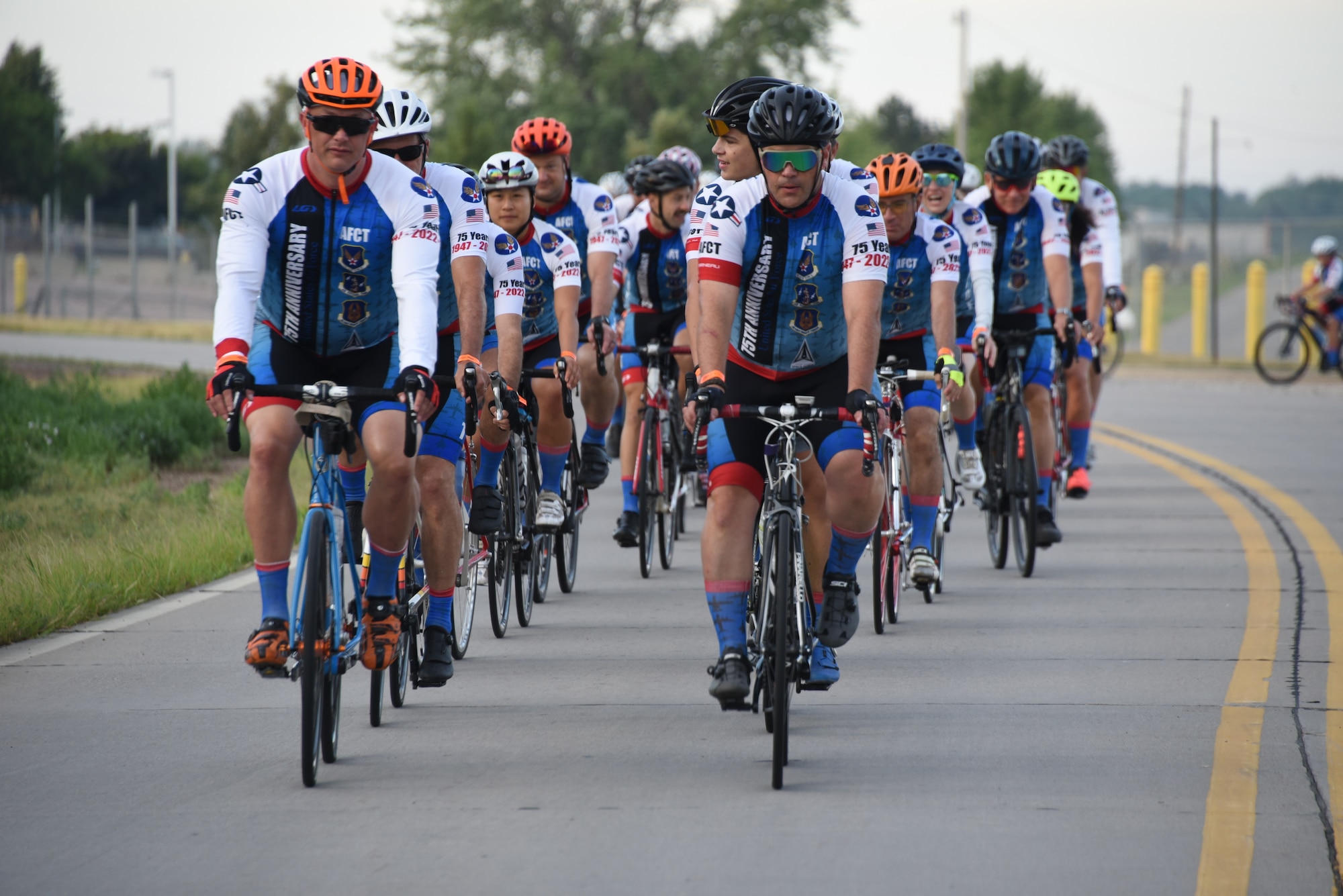 AFCT members ride down a road