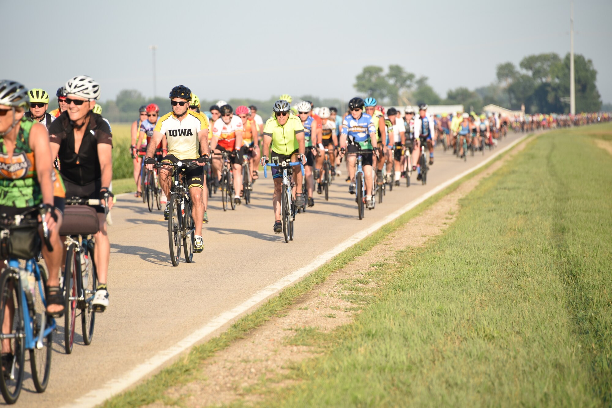 RAGBRAI riders ride bicycles down a road