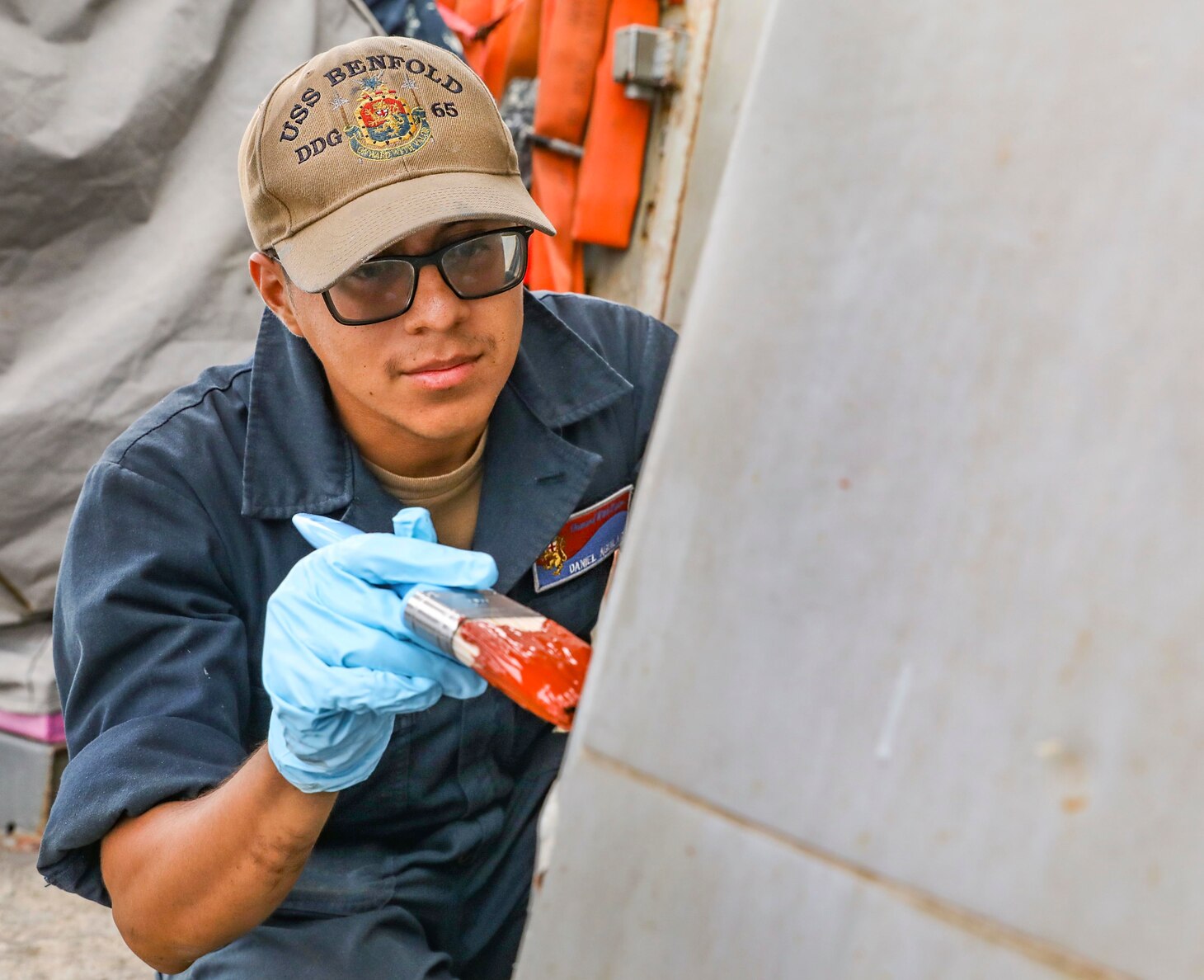 SEA OF JAPAN (Sept. 17, 2021) Seaman Daniel Aguilar, from Phoenix, applies primer to a bulkhead aboard Arleigh Burke-class guided-missile destroyer USS Benfold (DDG 65). Benfold is assigned to Commander, Task Force (CTF) 71/Destroyer Squadron (DESRON) 15, the Navy’s largest forward-deployed DESRON and the U.S. 7th Fleet’s principal surface force. (U.S. Navy photo by Mass Communication Specialist 1st Class Deanna Gonzales)