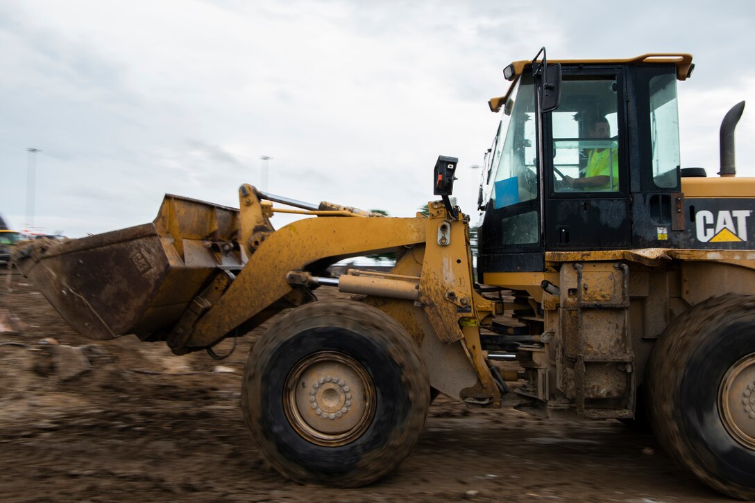 Heavy machinery moves dirt to make way for new construction at Offutt Air Force Base, Neb., July 7, 2022.