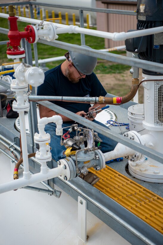 Contractors working with the U.S. Army Corps of Engineers, Omaha District, make the final adjustments to fuels tanks before a commissioning inspection at Offutt Air Force Base, Neb., June 22, 2022.
