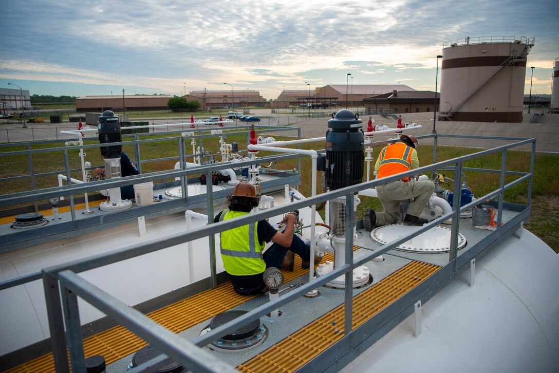 Contractors working with the U.S. Army Corps of Engineers, Omaha District, make the final adjustments to fuels tanks before a commissioning inspection at Offutt Air Force Base, Neb., June 22, 2022.