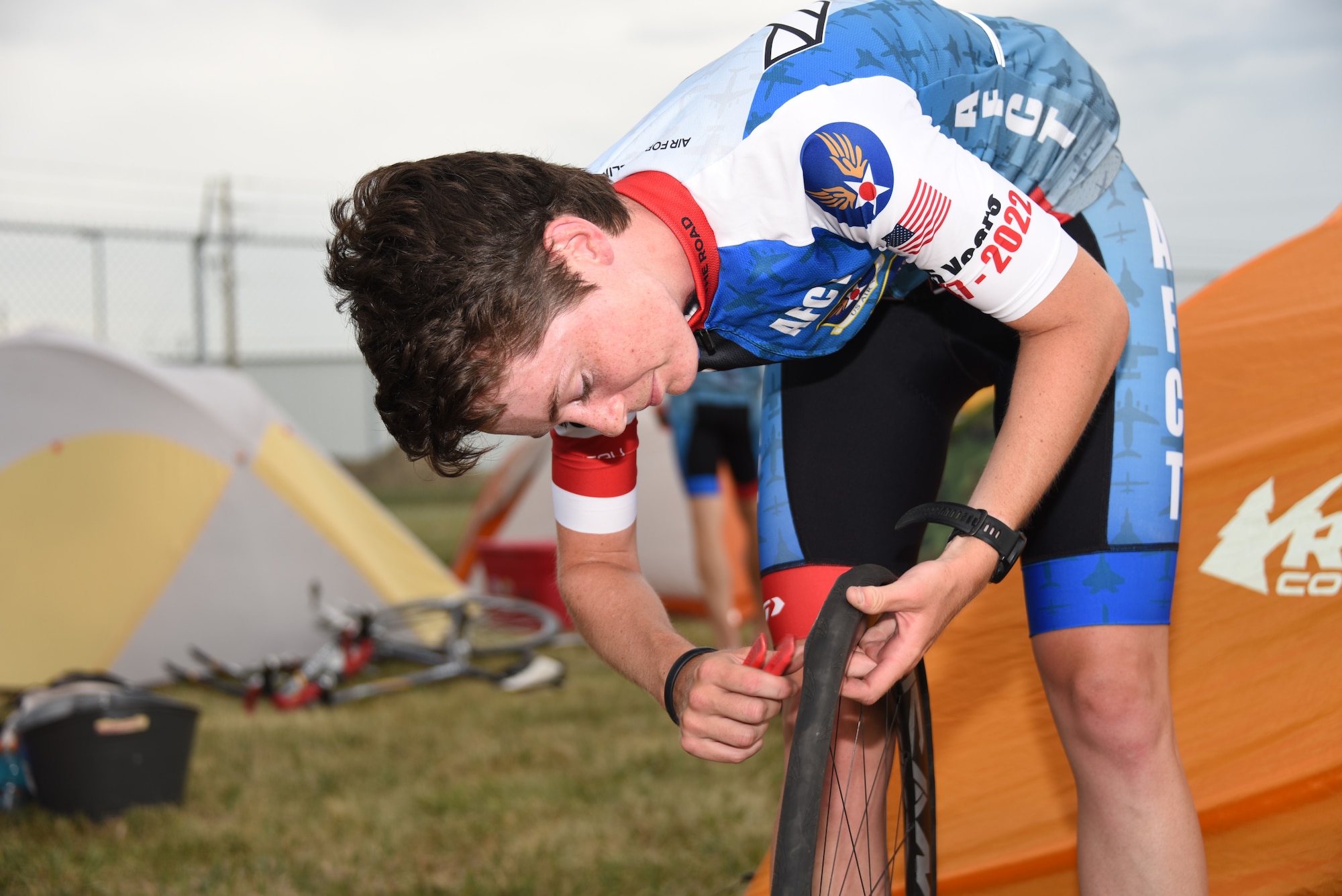 An AFCT member prepares a bicycle tire