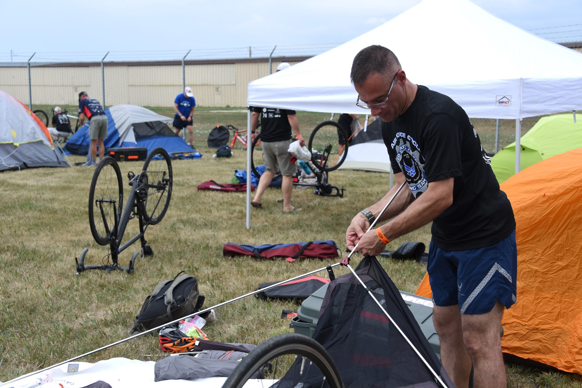 An AFCT member sets up his tent