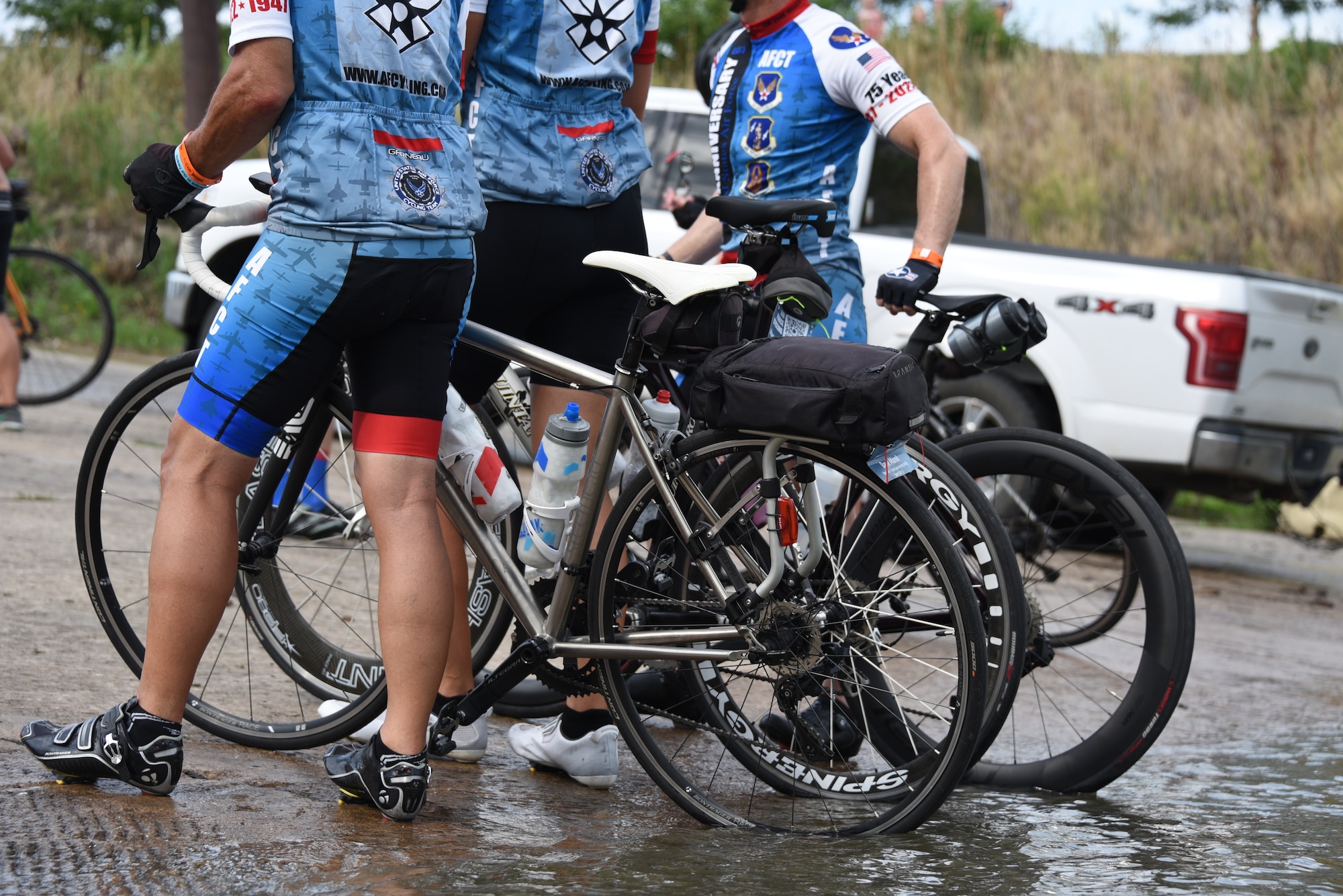 AFTC members dip their bicycle tires into water