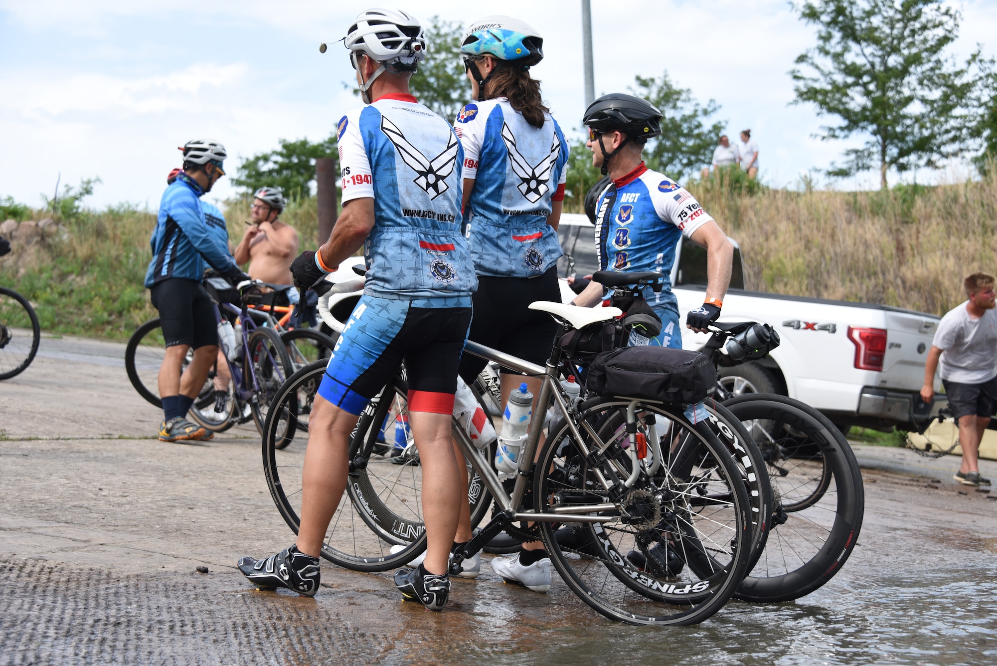 AFCT members dip their bicycle tires into water