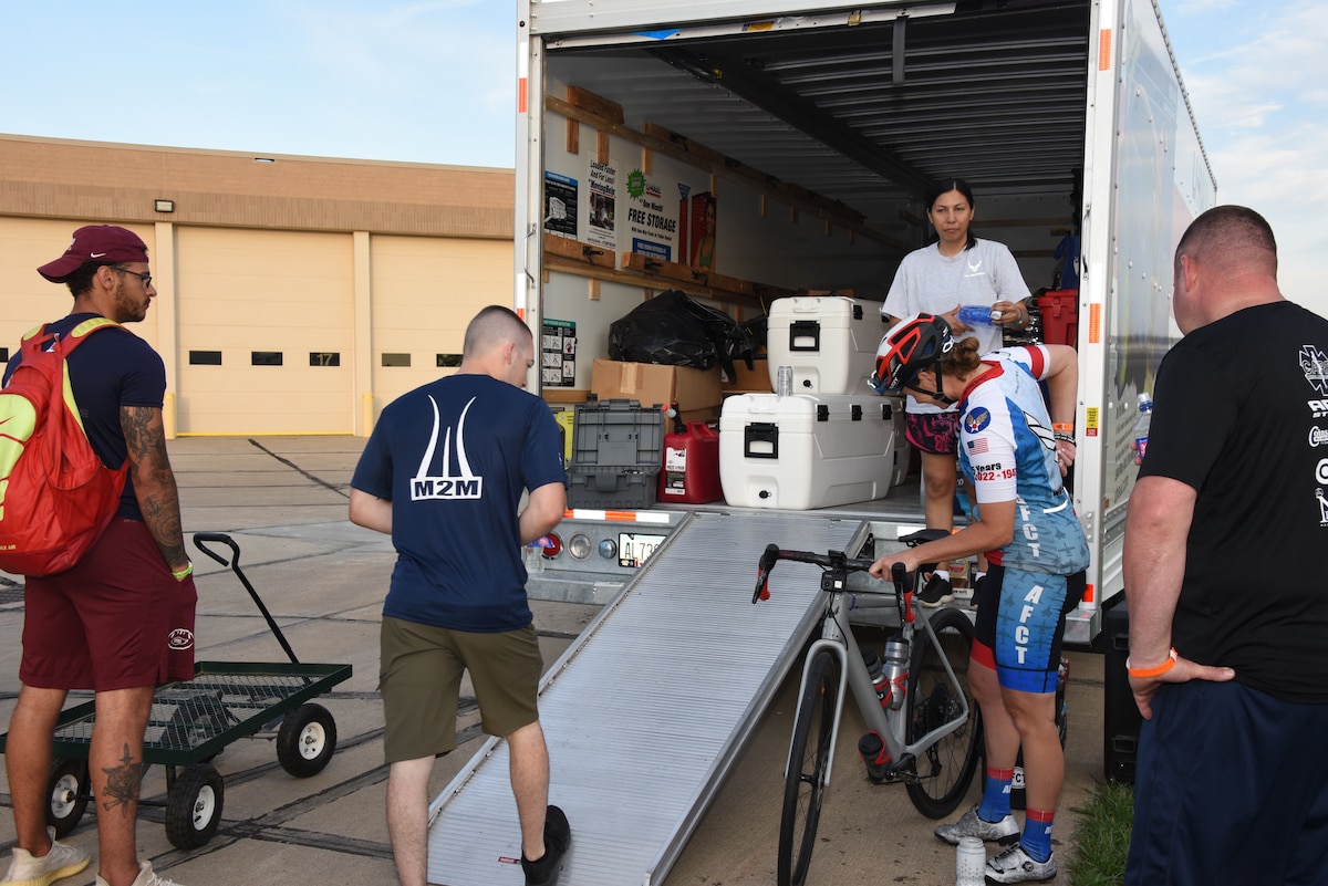 AFCT and support team members load equipment into a truck