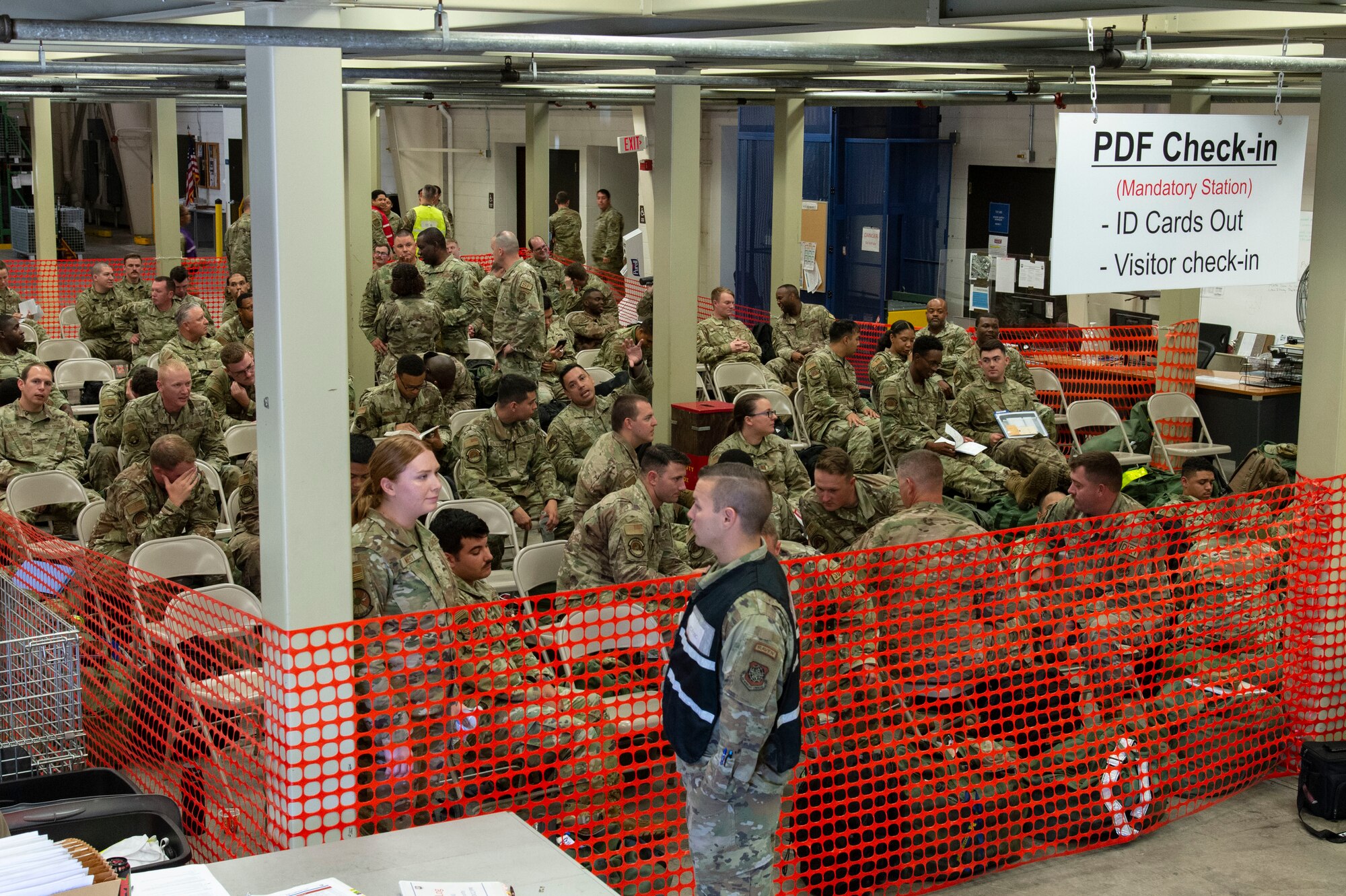 Team Dover members wait in the personnel deployment function line check-in area during Liberty Eagle Readiness Exercise 2022 at Dover Air Force Base, Delaware, July 11, 2022. The 436th and 512th Airlift Wings tested their ability to generate, employ and sustain airpower across the world in a simulated contested and degraded operational environment. (U.S. Air Force photo by Roland Balik)