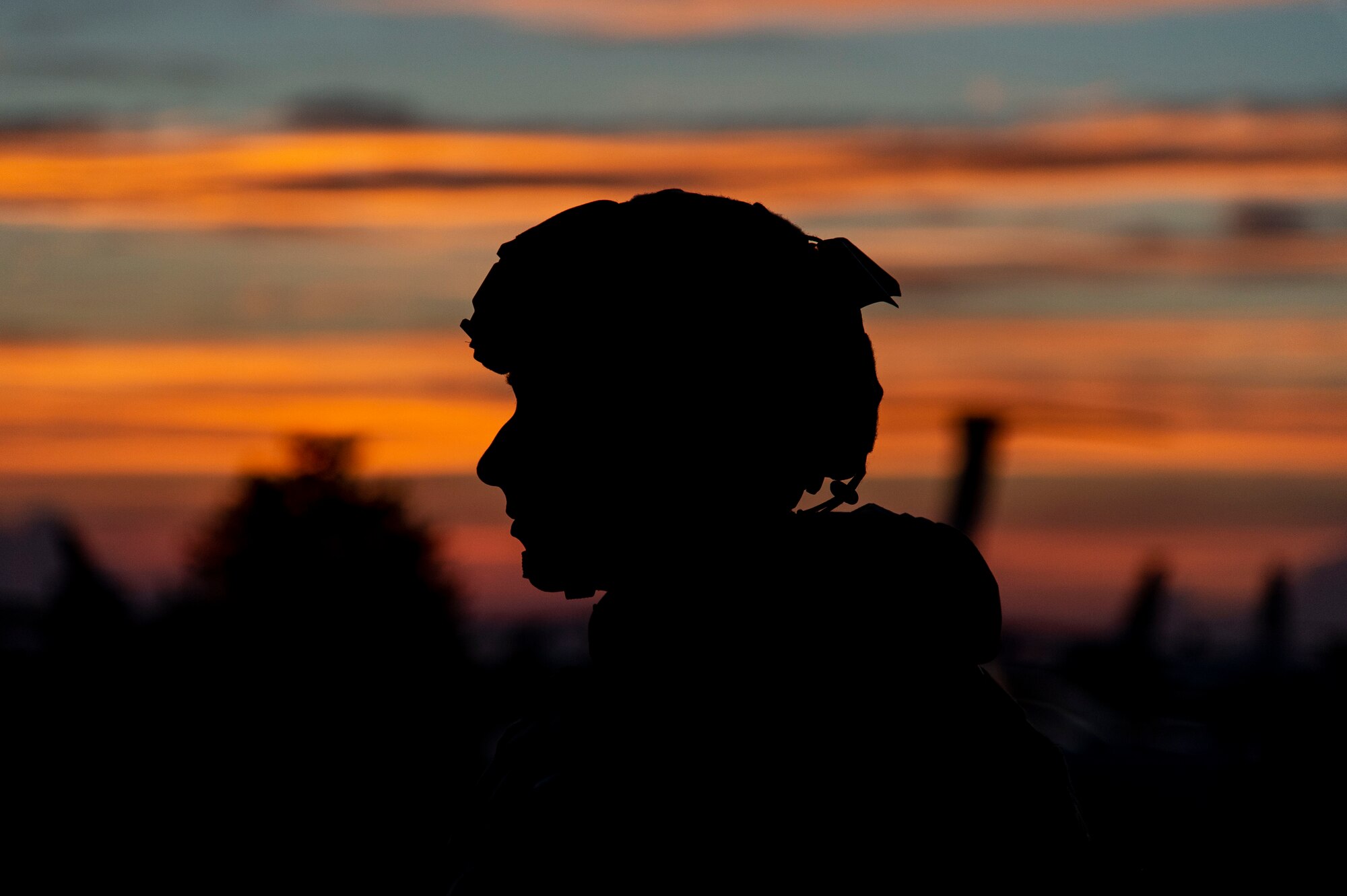 A Team Dover member stands guard at sunset during Liberty Eagle Readiness Exercise 2022 at Dover Air Force Base, Delaware, July 13, 2022. The 436th and 512th Airlift Wings tested their ability to generate, employ and sustain airpower across the world in a contested and degraded operational environment. (U.S. Air Force photo by Roland Balik)