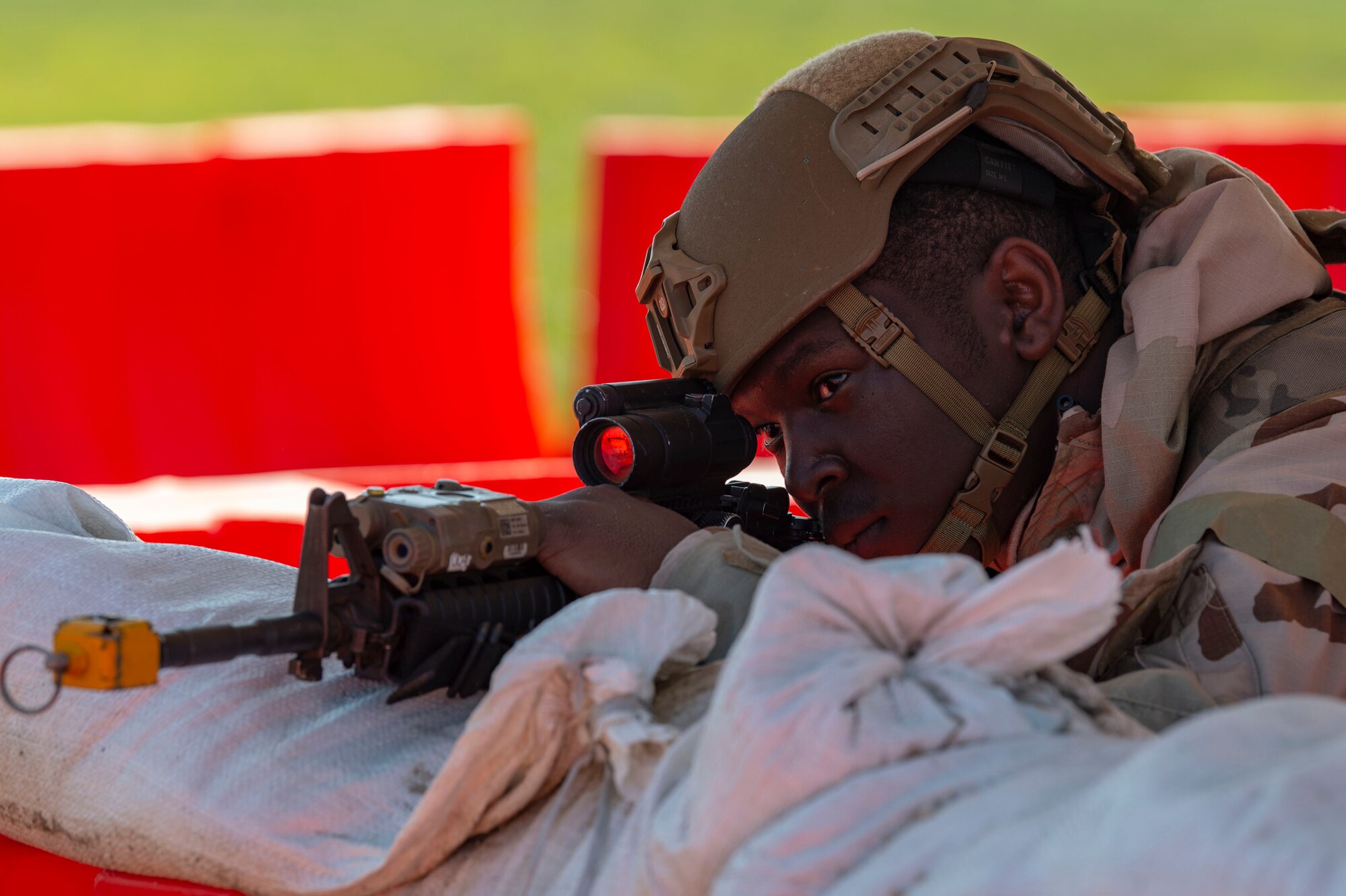 A Team Dover member stands guard against possible intruders at a simulated forward operating base during Liberty Eagle Readiness Exercise 2022 at Dover Air Force Base, Delaware, July 13, 2022. The 436th and 512th Airlift Wings tested their ability to generate, employ and sustain airpower across the world in a contested and degraded operational environment. (U.S. Air Force photo by Roland Balik)