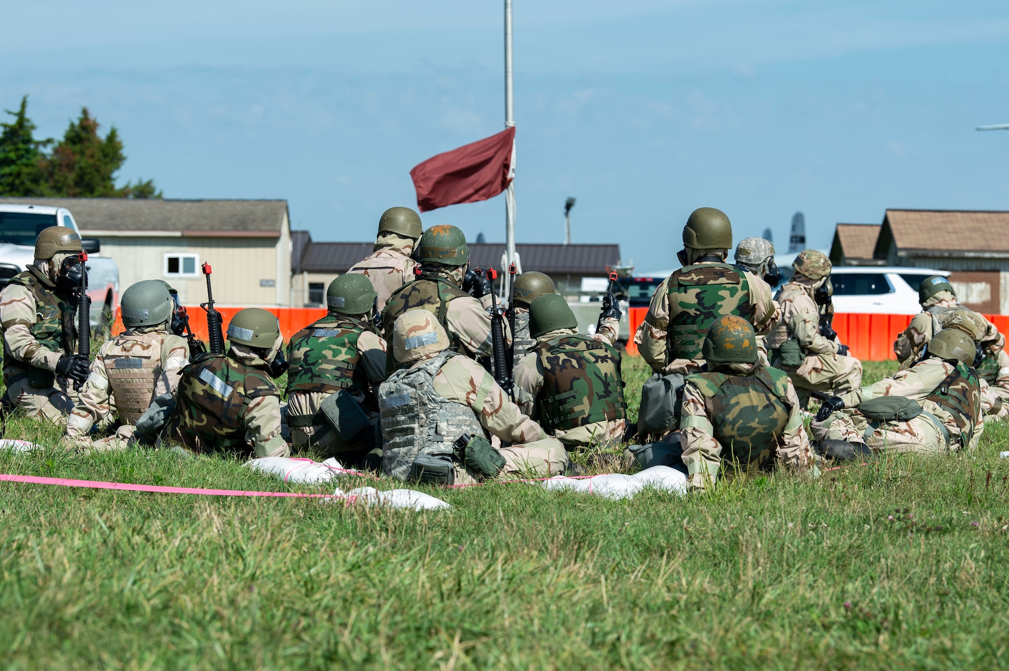 During a simulated attack, Team Dover members wearing training protective gear huddle in simulated shelters at a forward operating base during Liberty Eagle Readiness Exercise 2022 at Dover Air Force Base, Delaware, July 13, 2022. The 436th and 512th Airlift Wings tested their ability to generate, employ and sustain airpower across the world in a contested and degraded operational environment. (U.S. Air Force photo by Roland Balik)